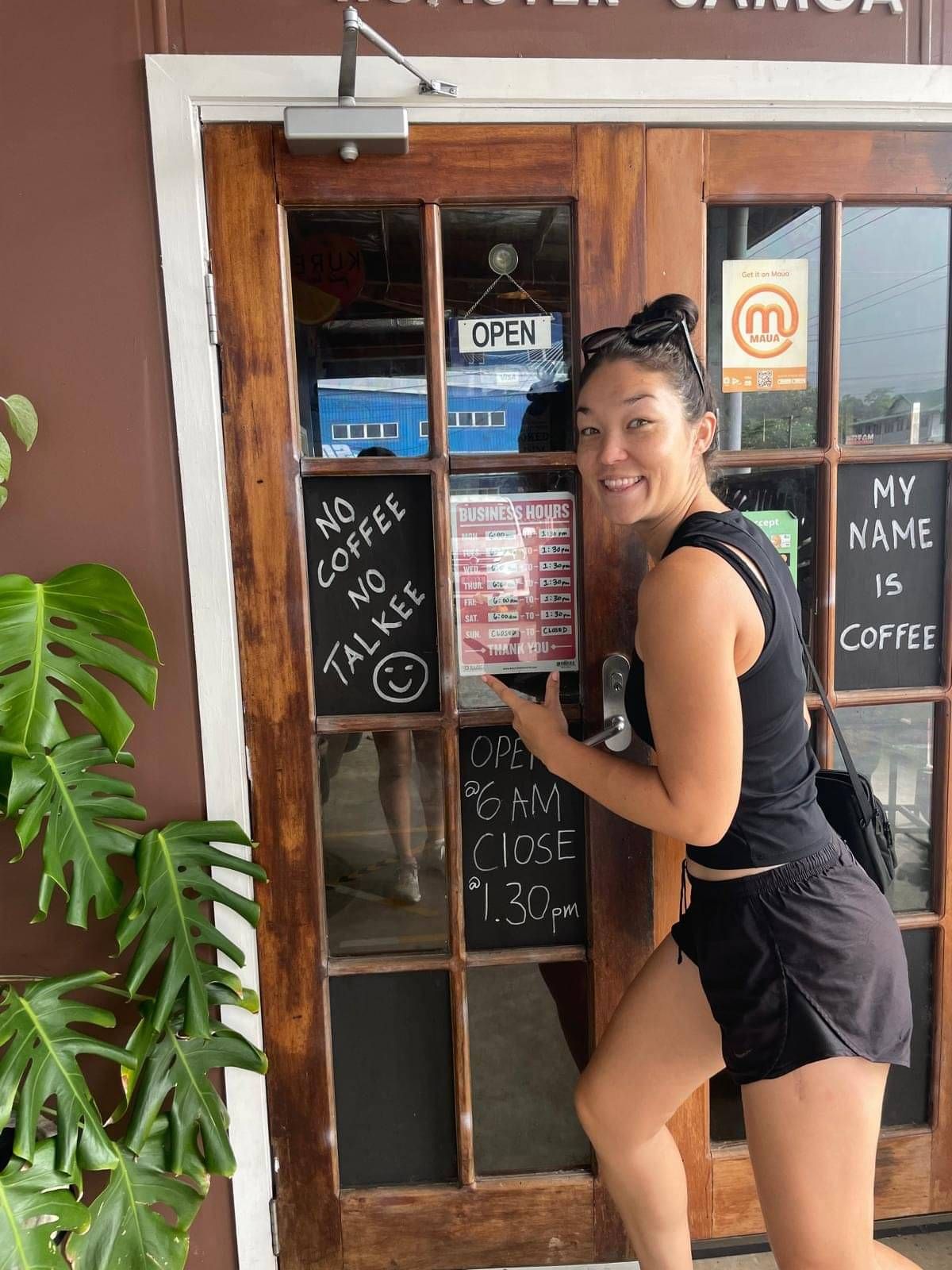 Salli standing next to sign - no coffee no talkee