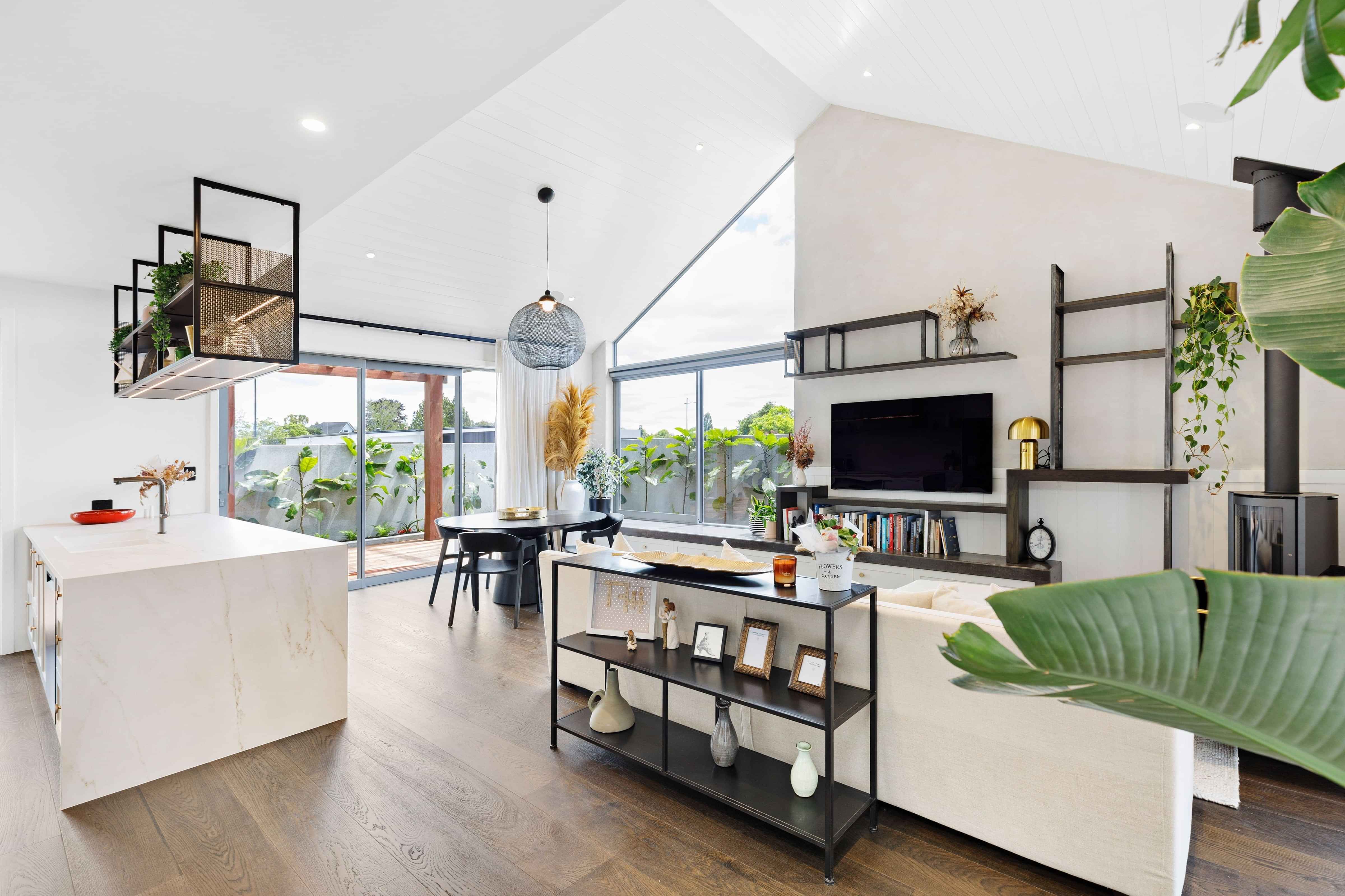 Image of the inside of a new architetural build. Open plan with expansive floor to ceiling windows
