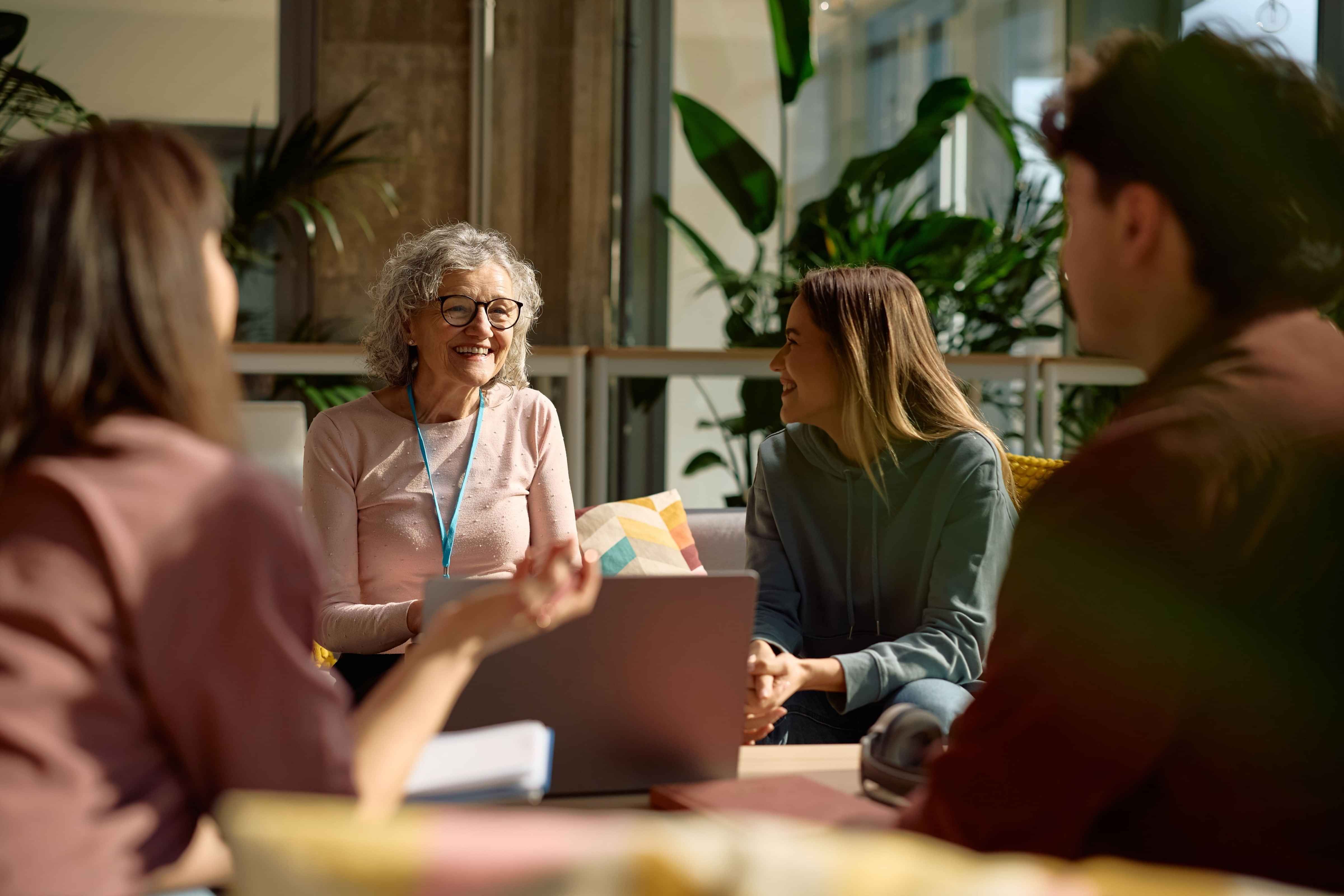 A group of people sitting around having a conversation
