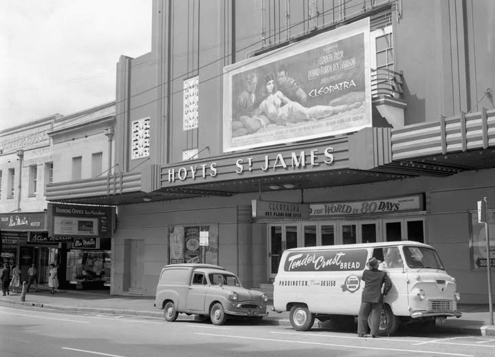 Two men admiring an old motor car