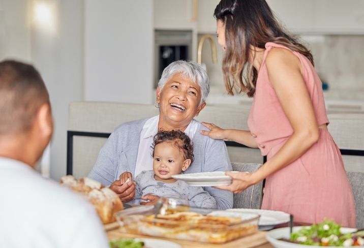 Older adult sharing a meal with her family
