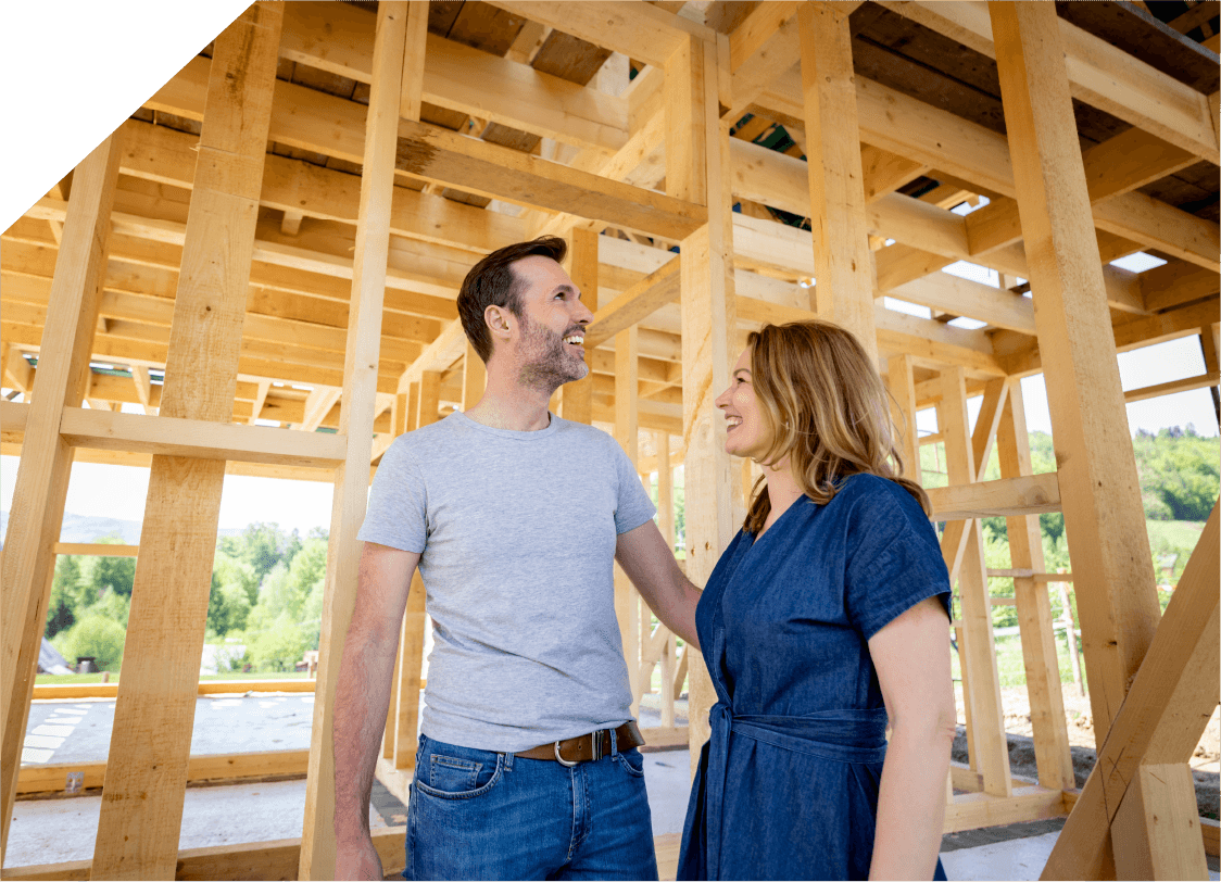 Happy couple in house under construction