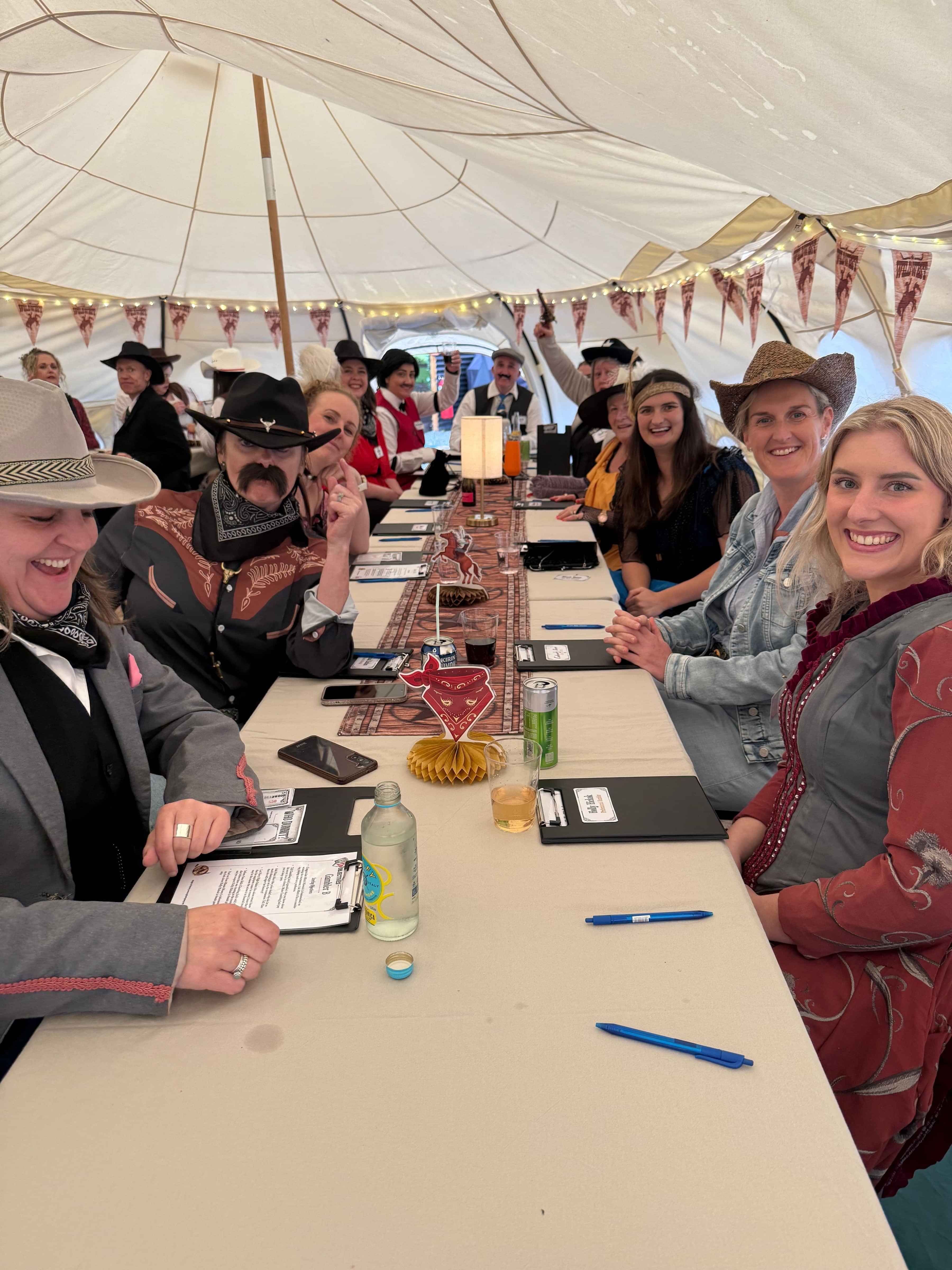“Guests participating in a Wild West themed Mystery Murder party at Forest Hillside Glamping Retreat.”