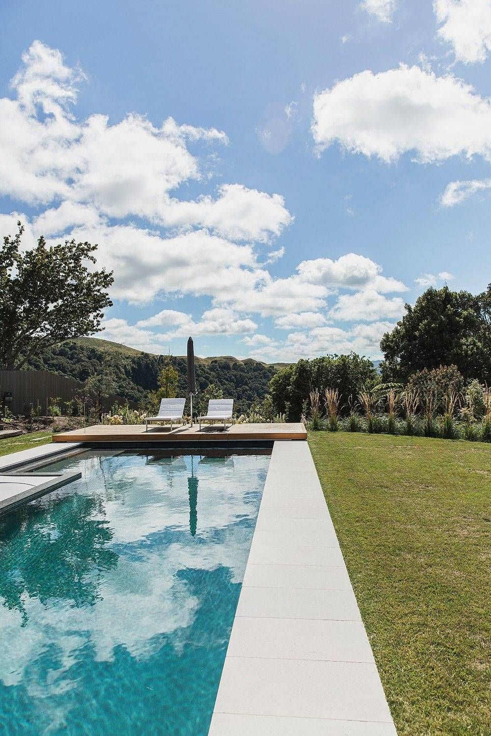 Landscape outdoor living design in Rotorua with pool and deck area for sunning