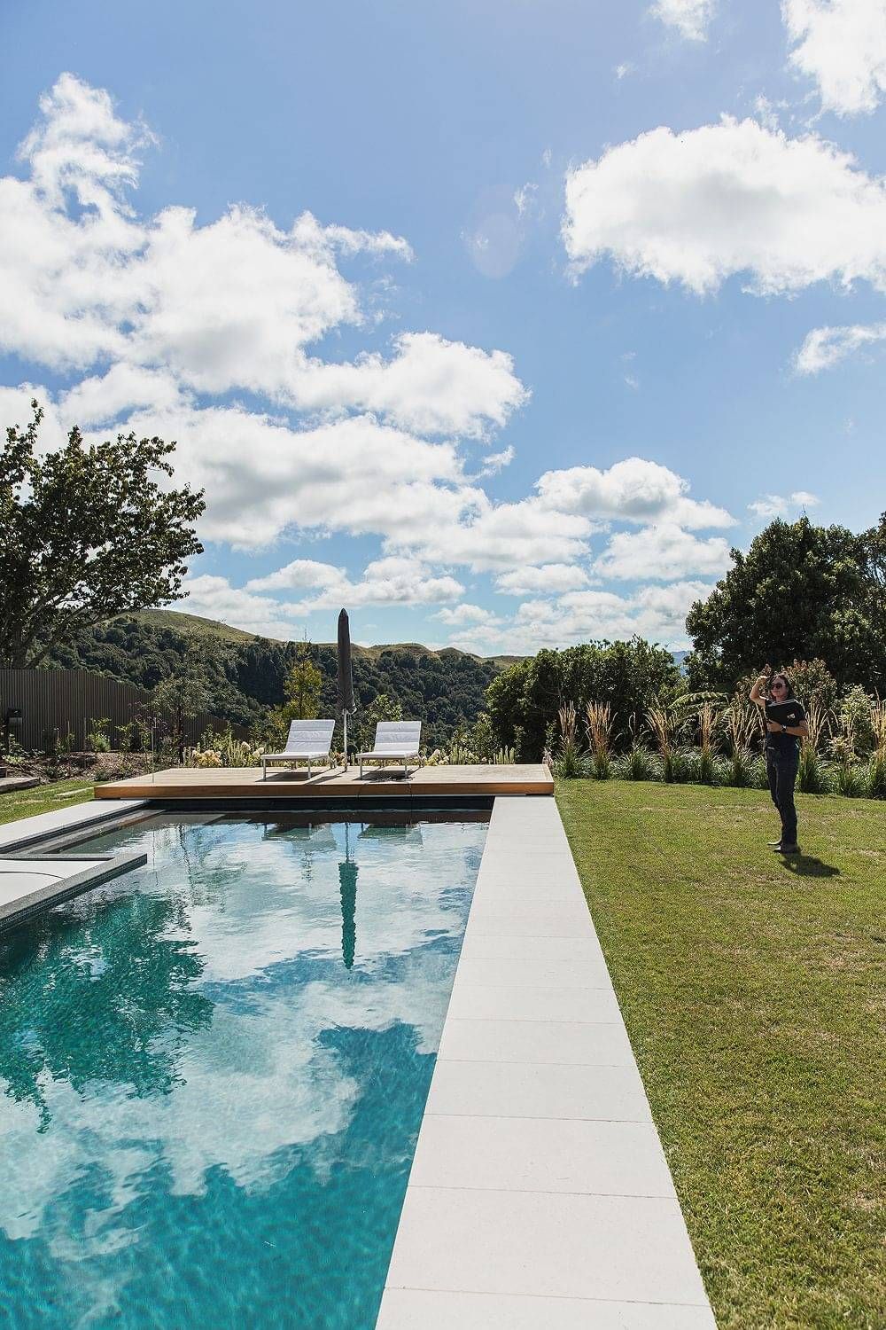 Landscape outdoor living design in Rotorua with pool and deck area for sunning