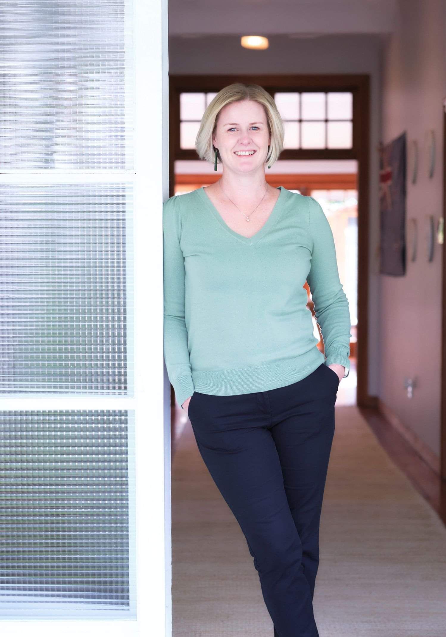 Photo of Claire Turner from Two Little Birds Consulting standing in a doorway