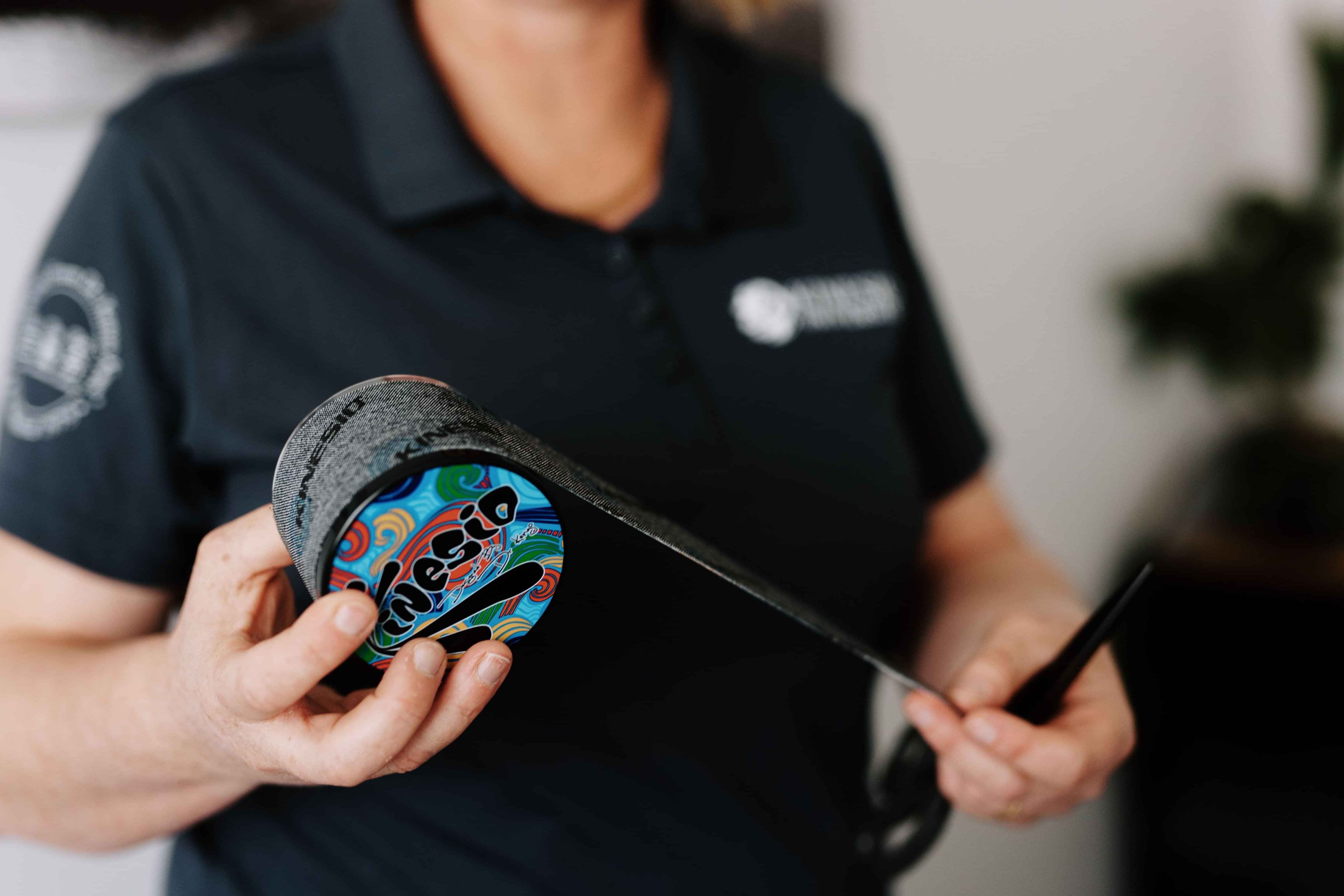 Image of Heather Lever placing Kinesio Tape on a patient. Join the Kinesio Taping Foundations Course. New Zealand based workshops available.