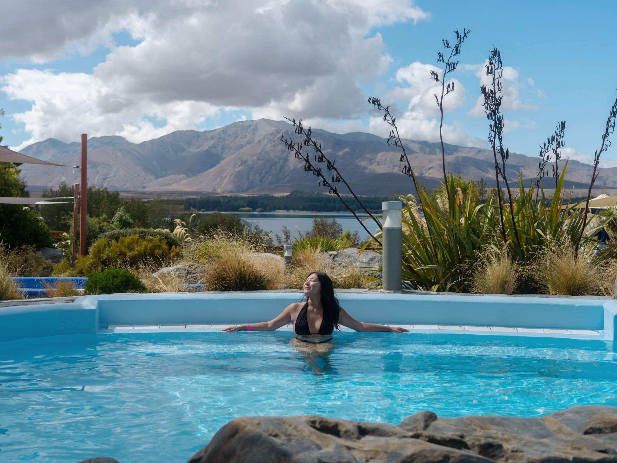 Outdoor hot pools at Tekapo Springs with views over Lake Tekapo and the Southern Alps