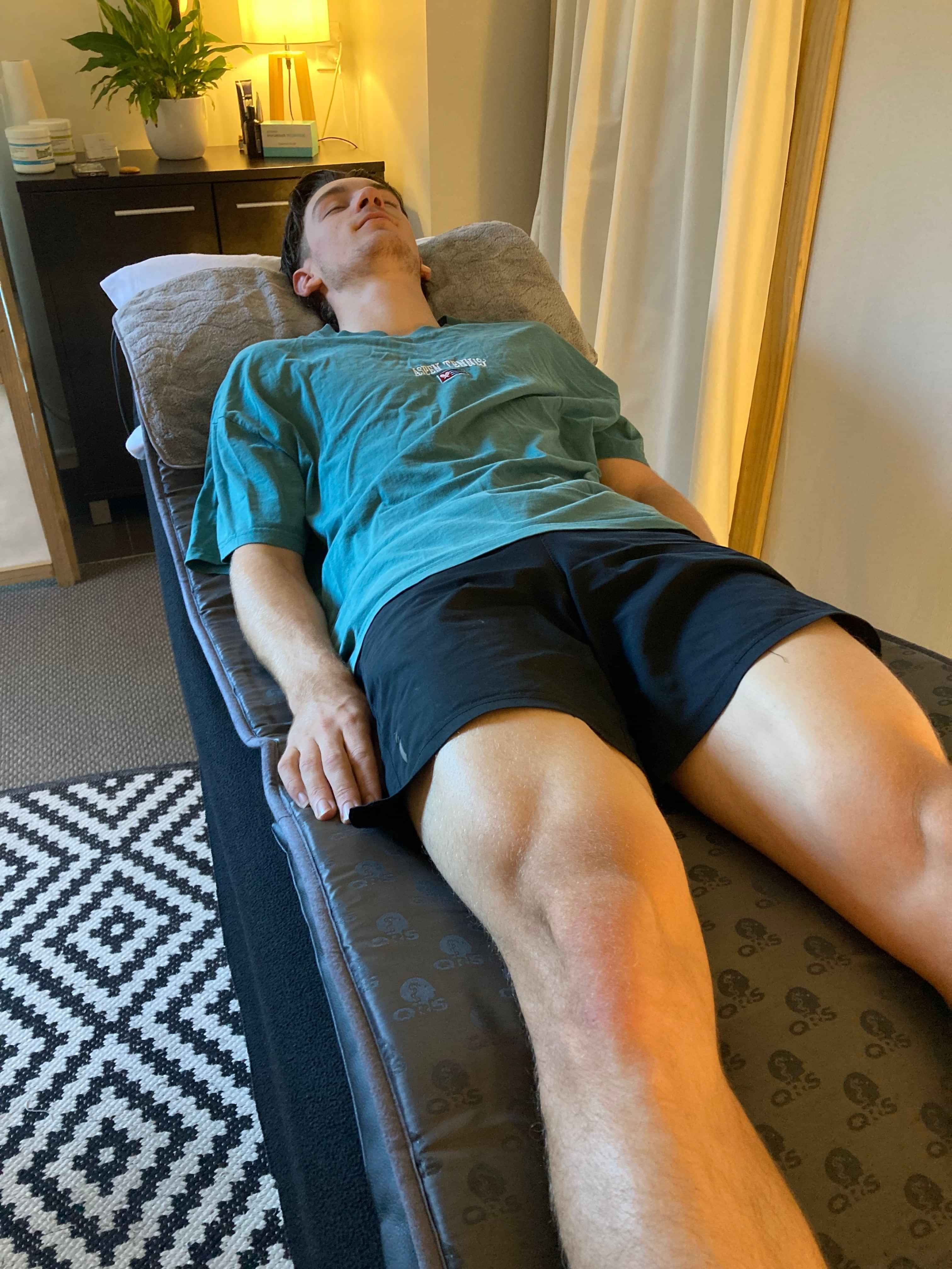 picture of massage table and pemf met with light in the background