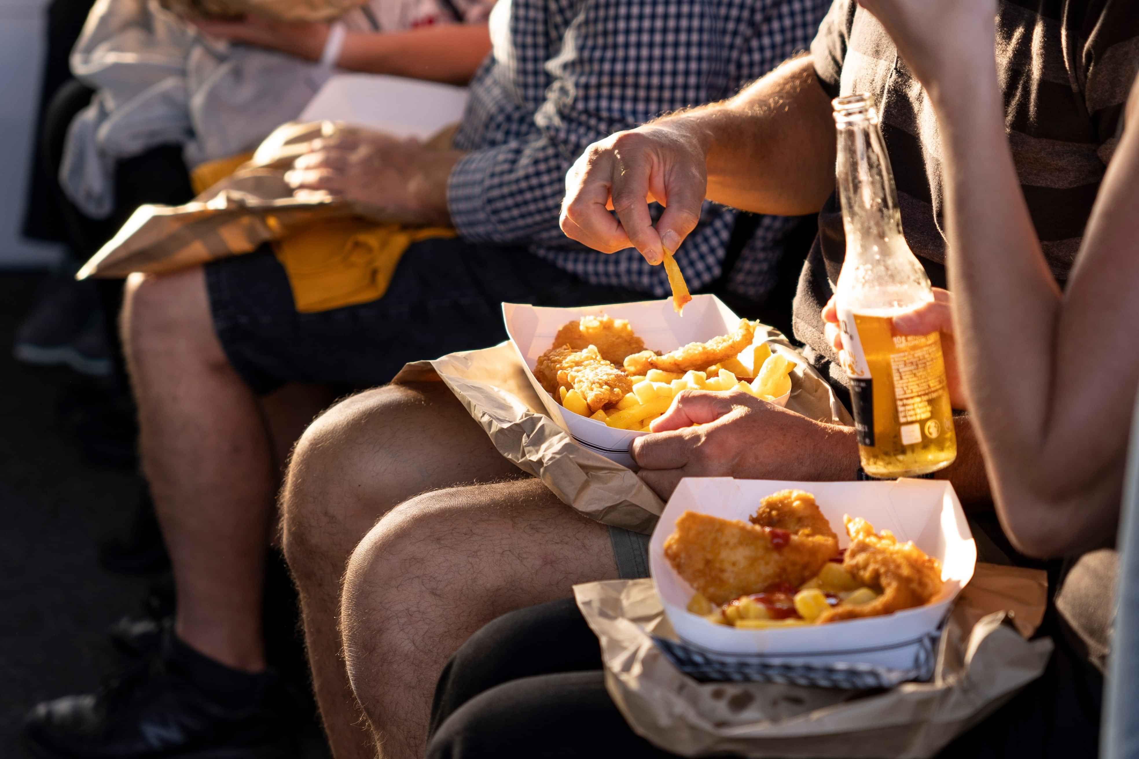 Enjoy a kiwi fish and chips dinner aboard your cruise