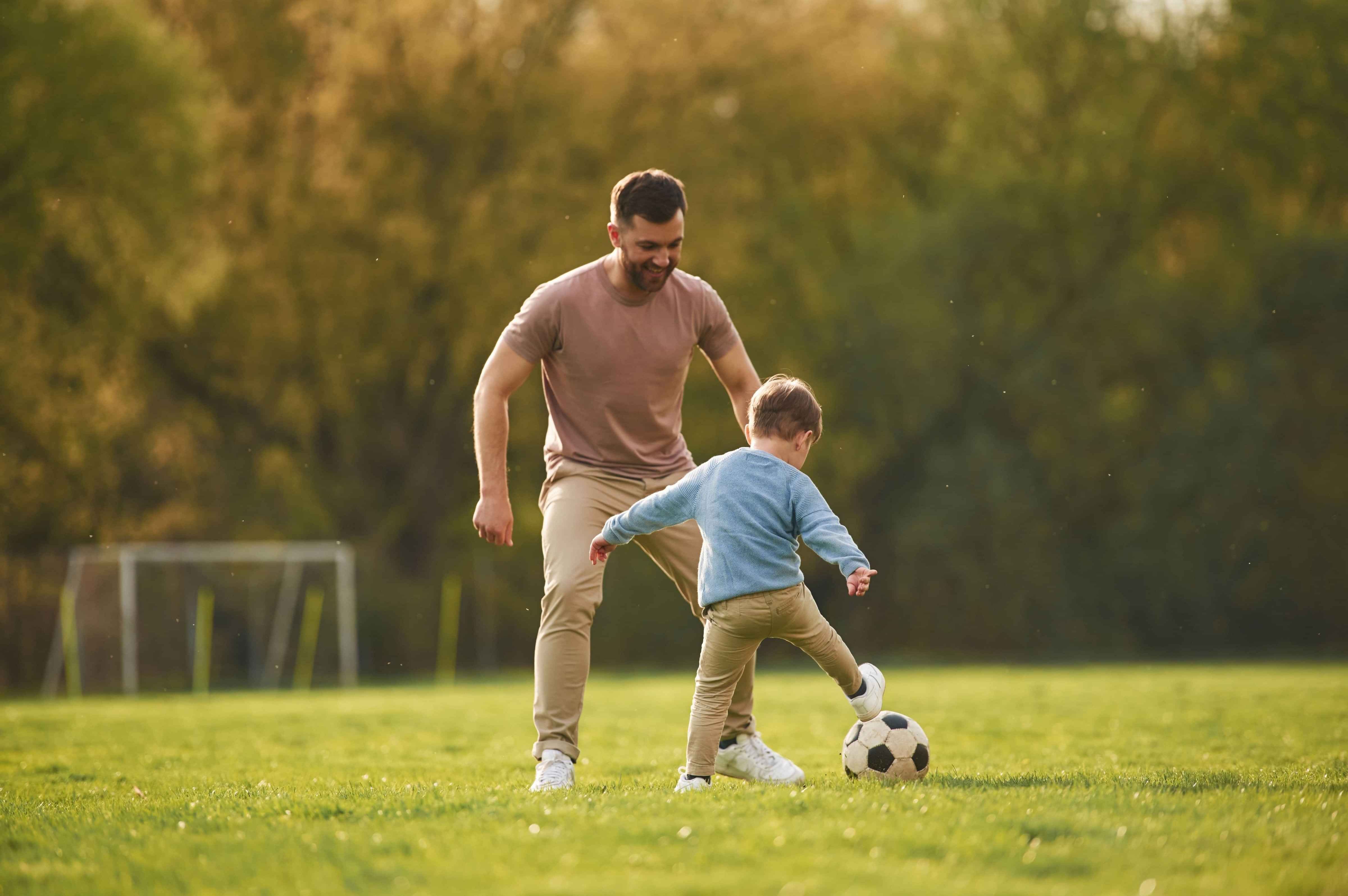 Father and son playing football