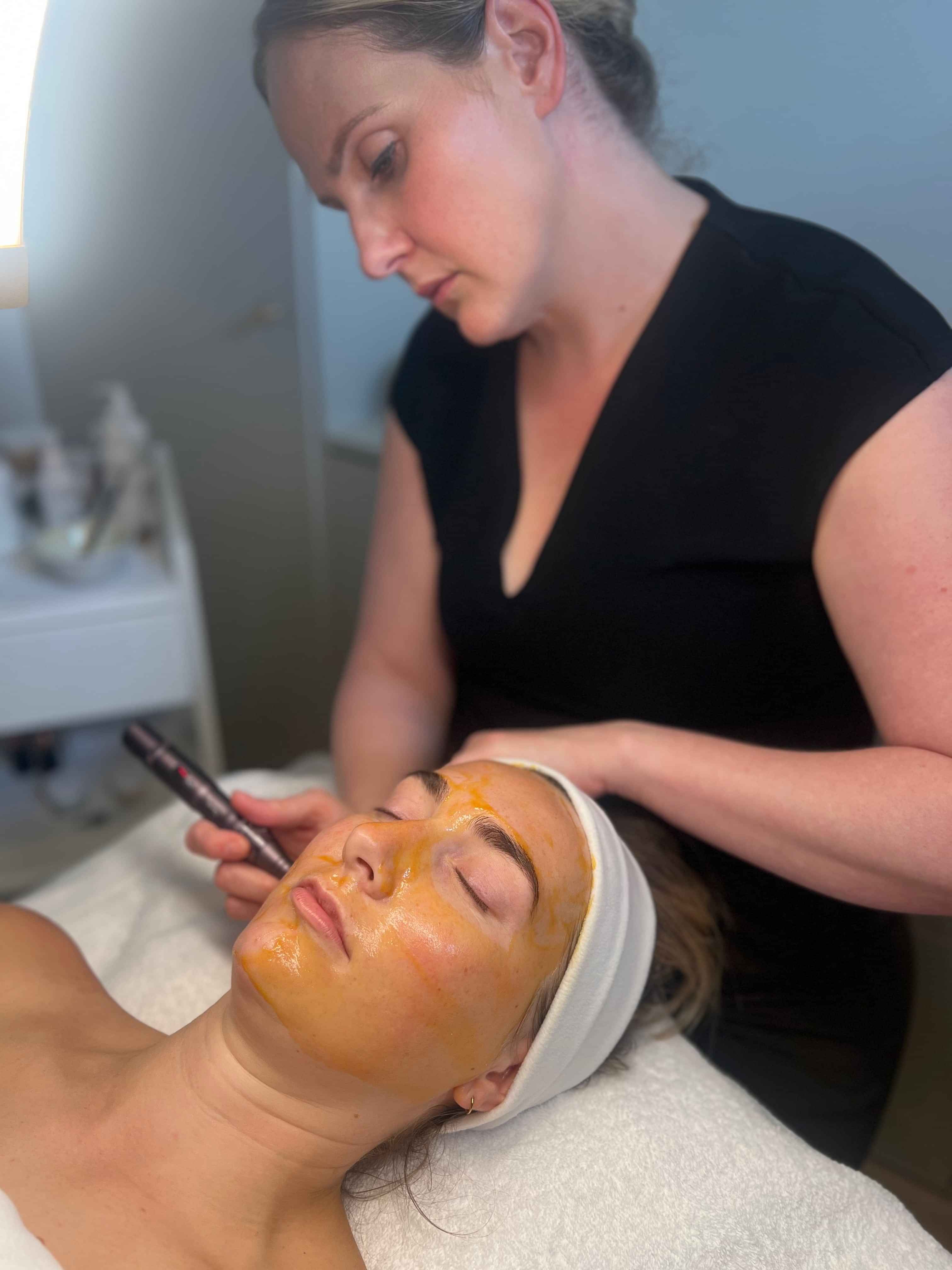 A client getting a results facial massage during a spa treatment.