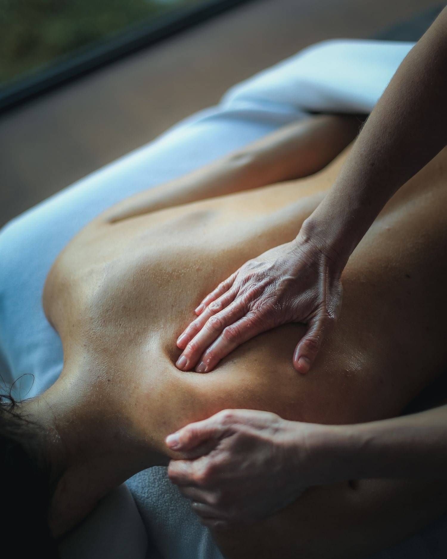 A clients back being expertly massaged by one of the Indulge team.