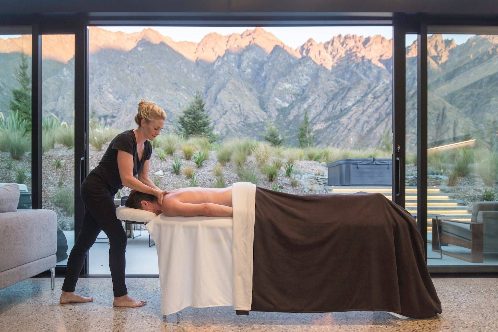 A clients neck and shoulders being expertly massaged by one of the Indulge team on location in Queenstown.
