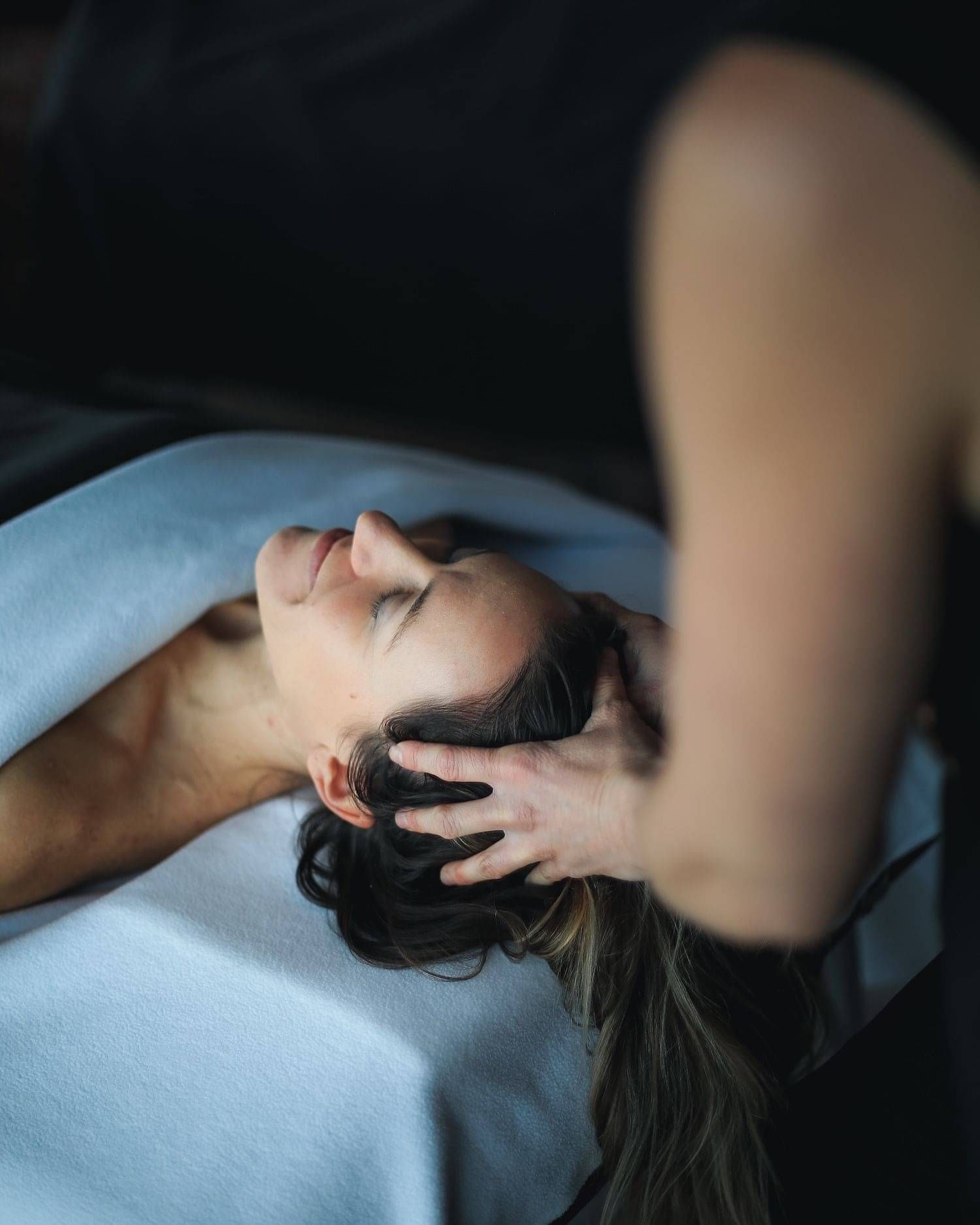 A client enjoying a scalp massage as part of their treatment by Indulge.