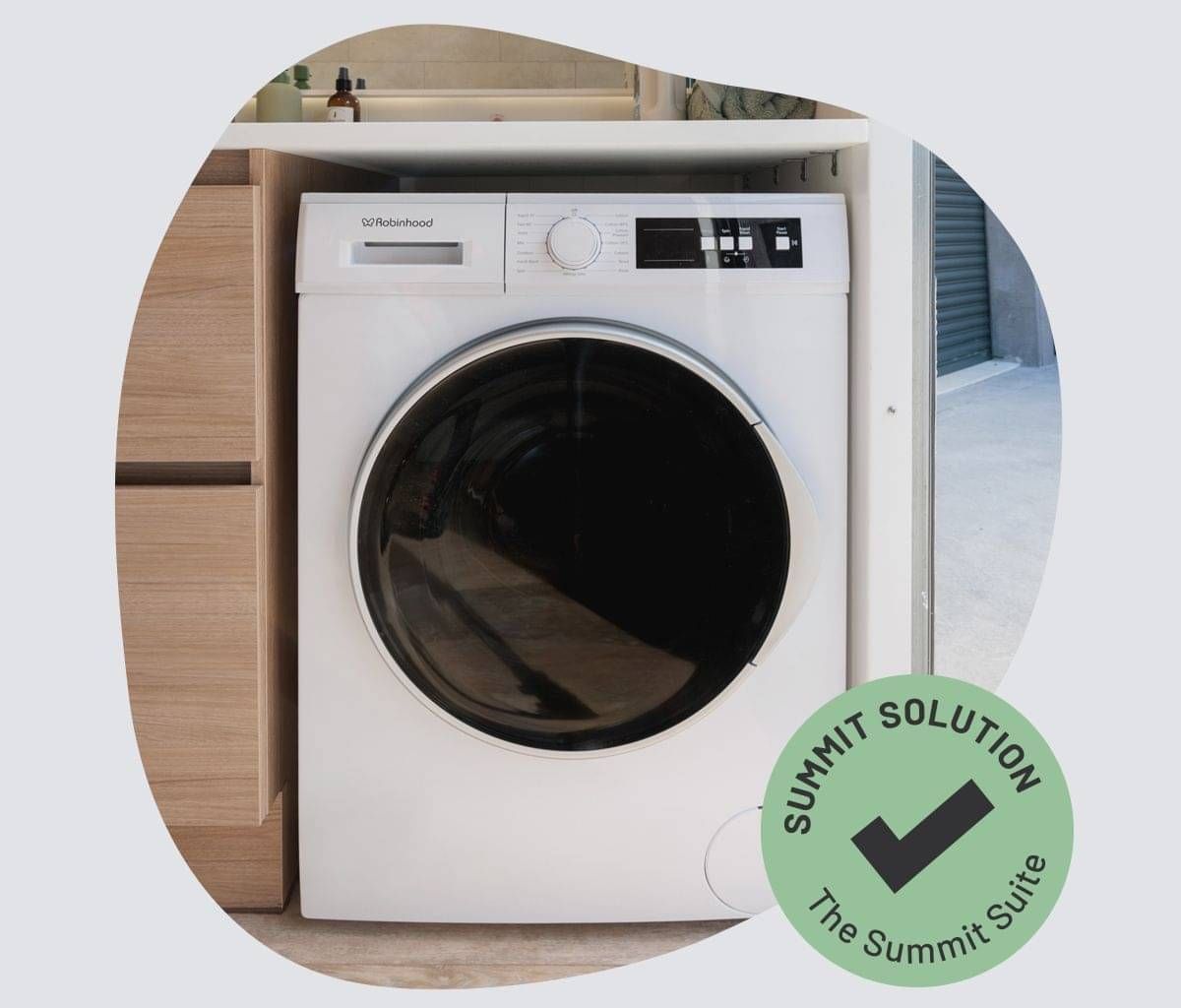 A washing machine fitted in a portable bathroom.