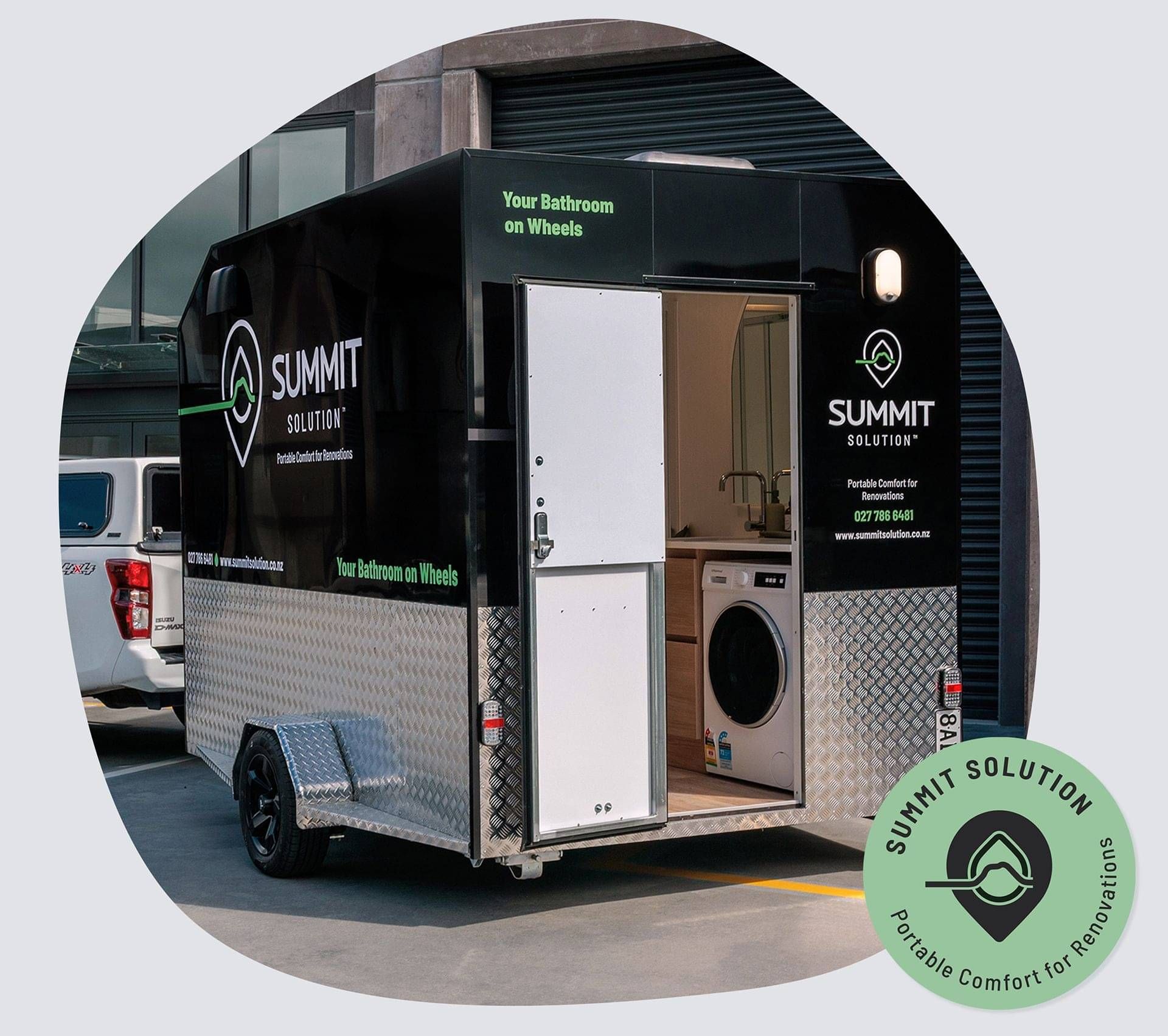 The Summit Suite which is a Portable Bathroom trailer with Washing Machine.