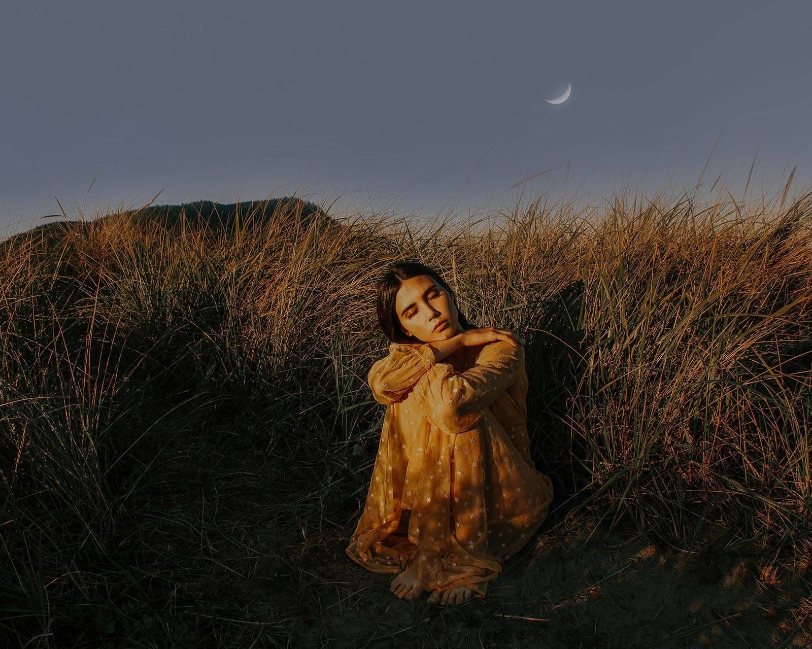 Photo of peaceful woman sitting in nature