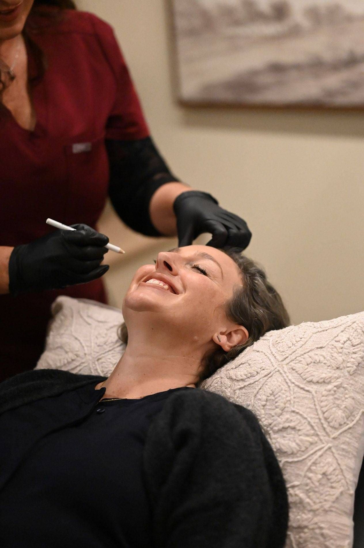 Photo of Kylie Dillon preparing a client for Cosmetic Treatment within Wllington