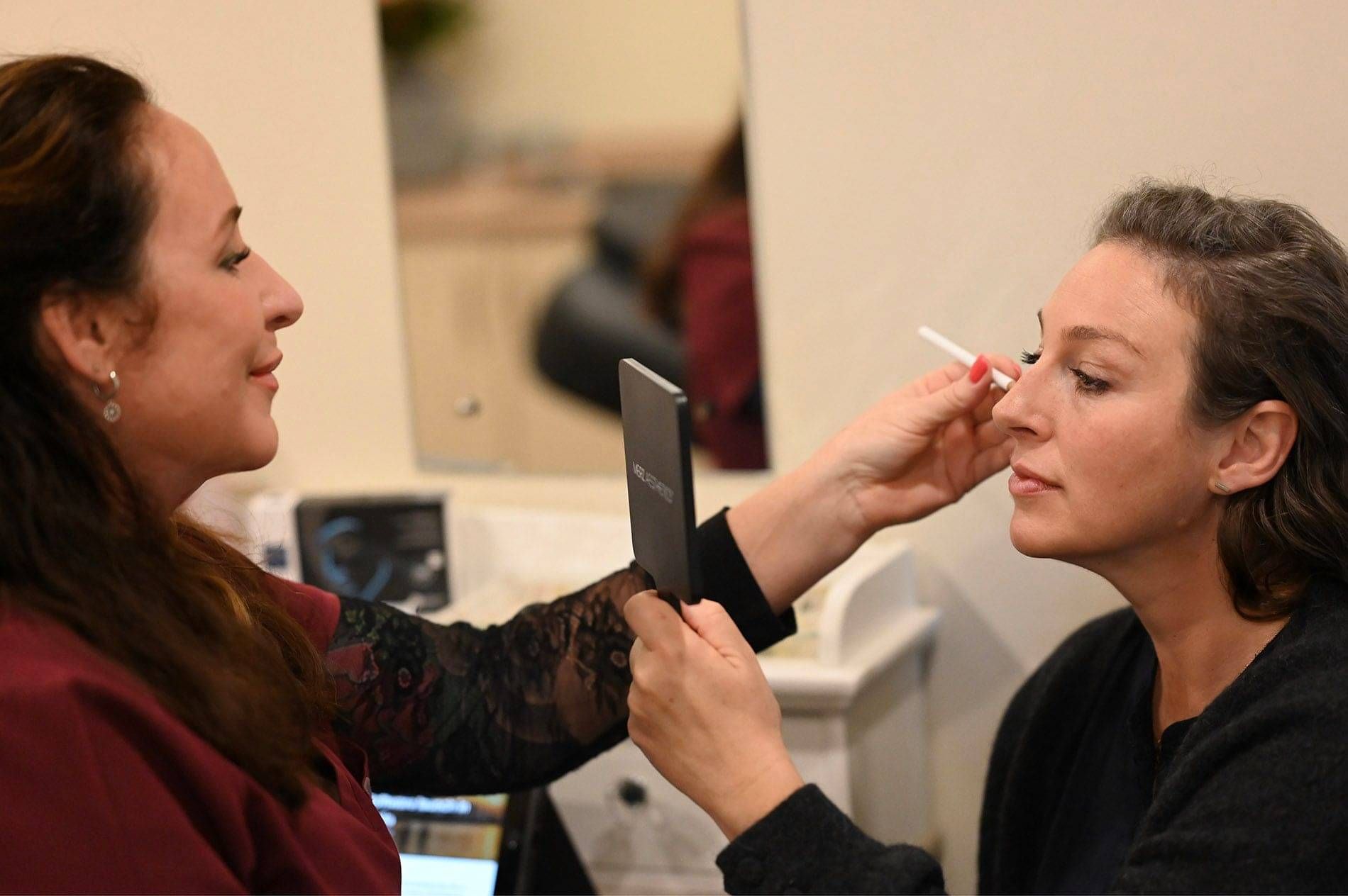 Photo of Kylie Dillon preparing a client for Cosmetic Treatment