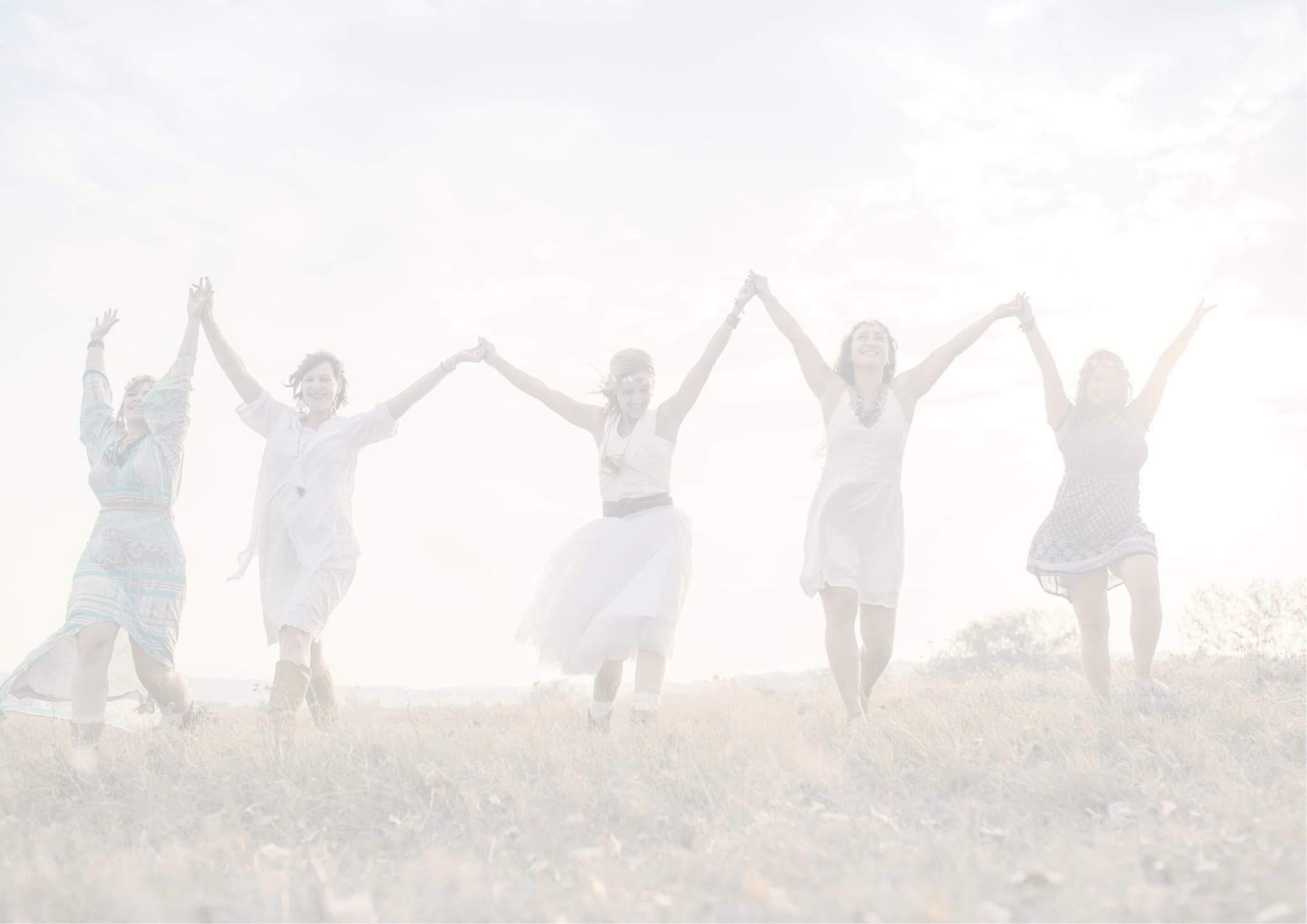 The silhouette of 6 women holding hands with them in the air