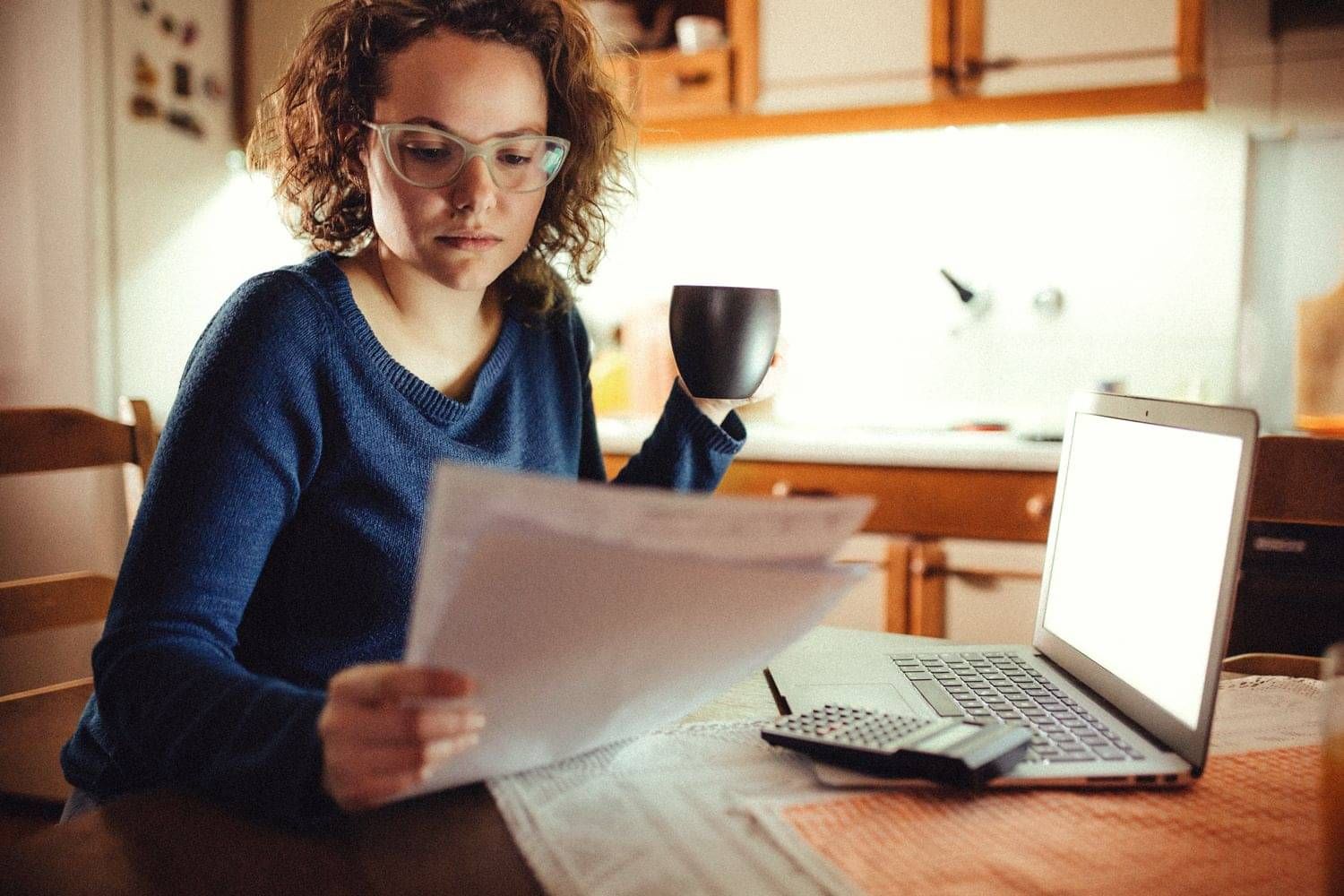 Women looking at documents and computer after separation
