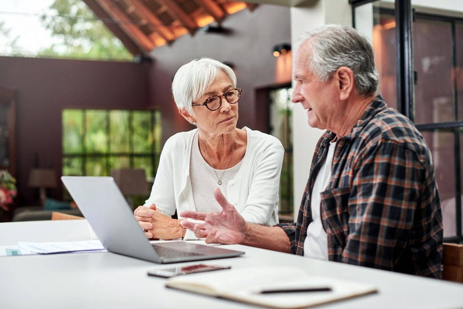 Older couple sitting at table discussing estate claims
