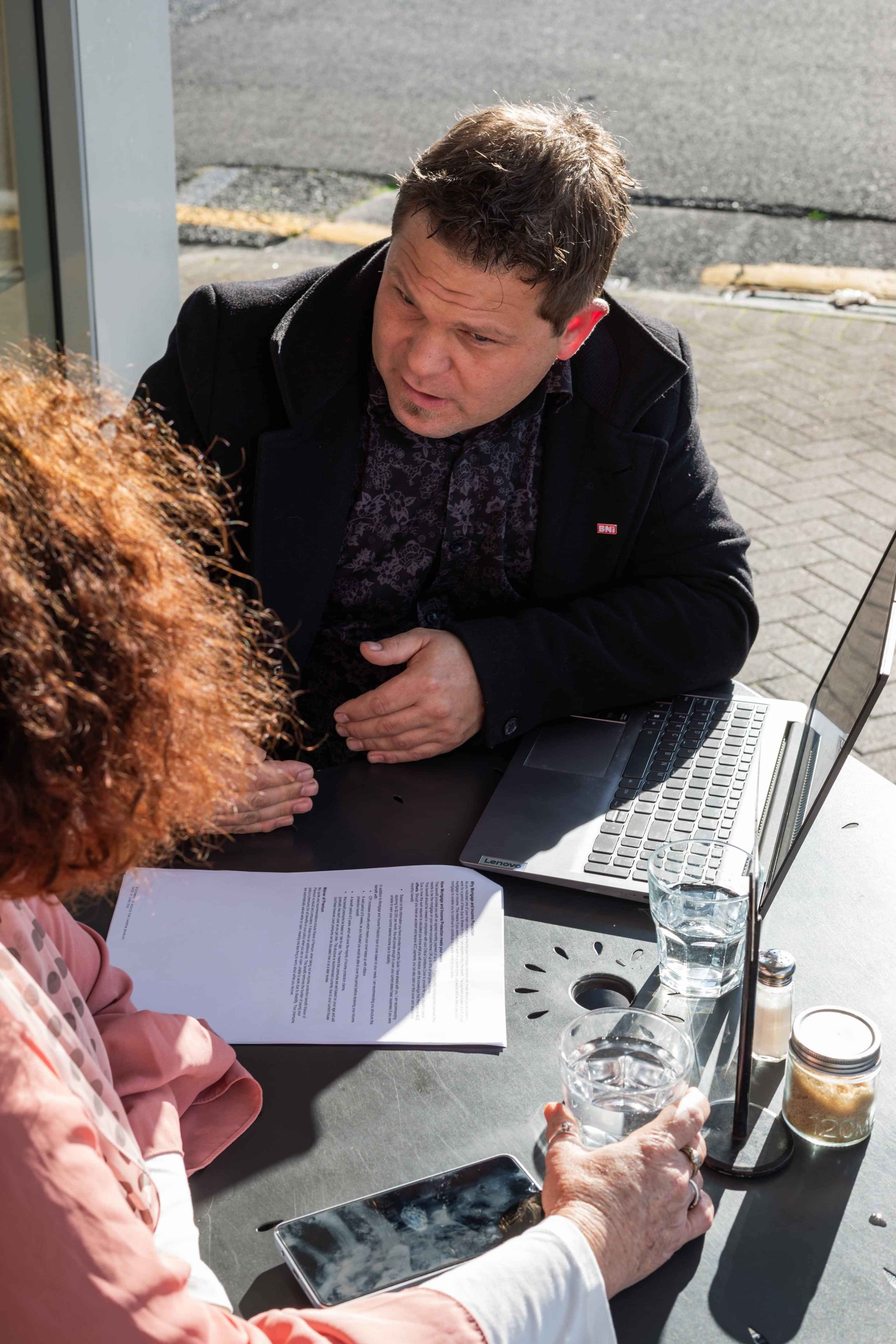 Insurance Advisor sitting down with a woman to talk about Trauma Insurance