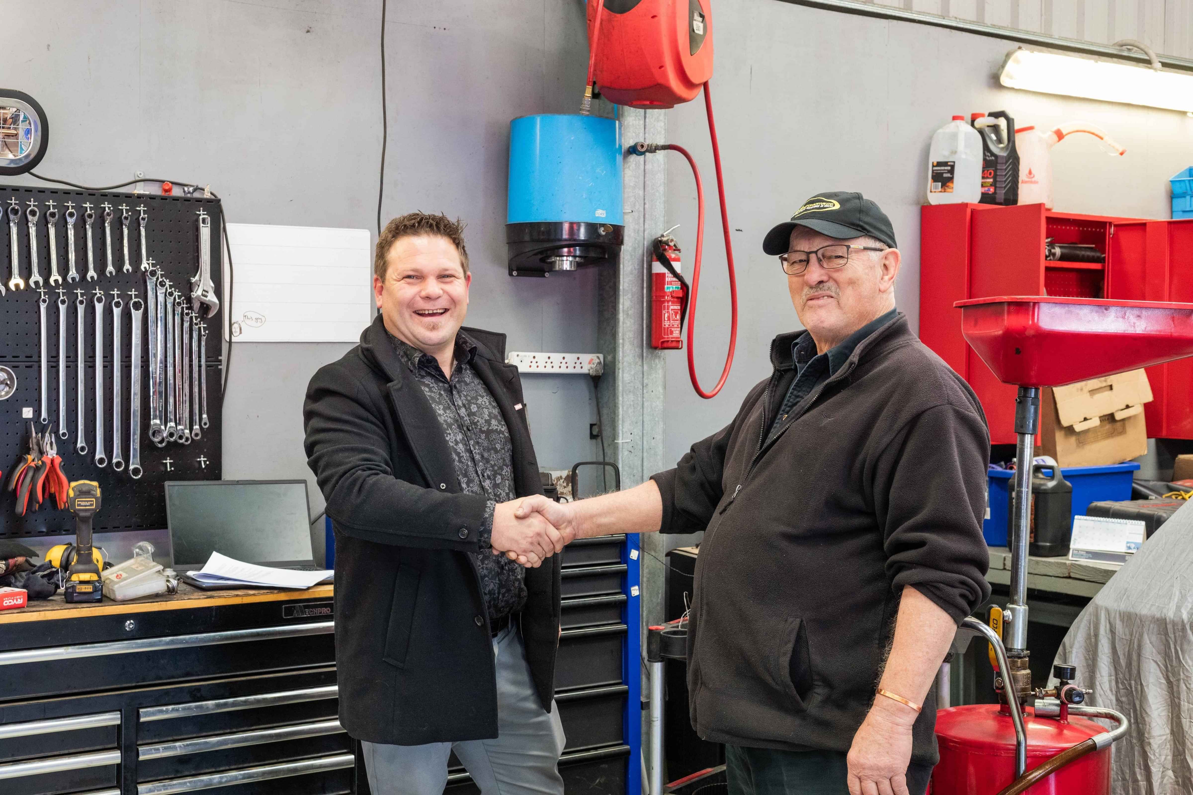 Insurance Adviser and a Mechanic shaking hands