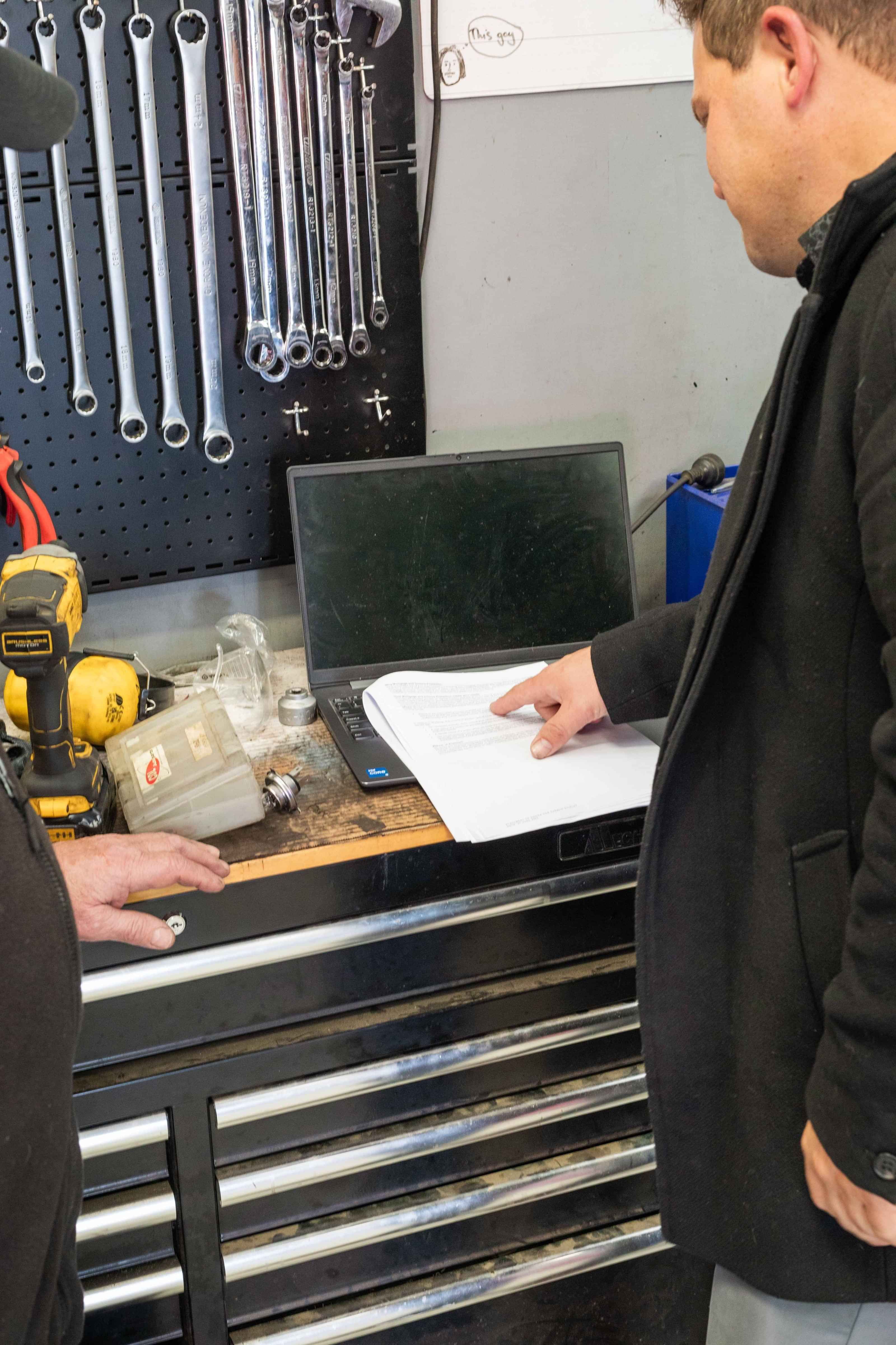 Looking over paperwork at a Mechanics workshop
