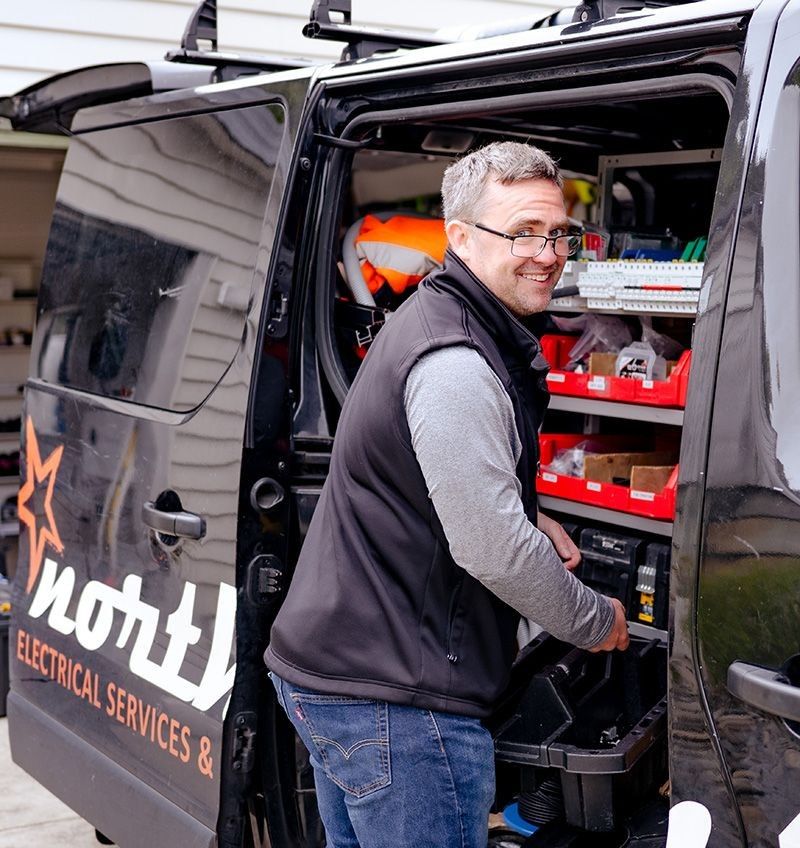 Northstar Technical Services Qualified Electrician at work van getting screws