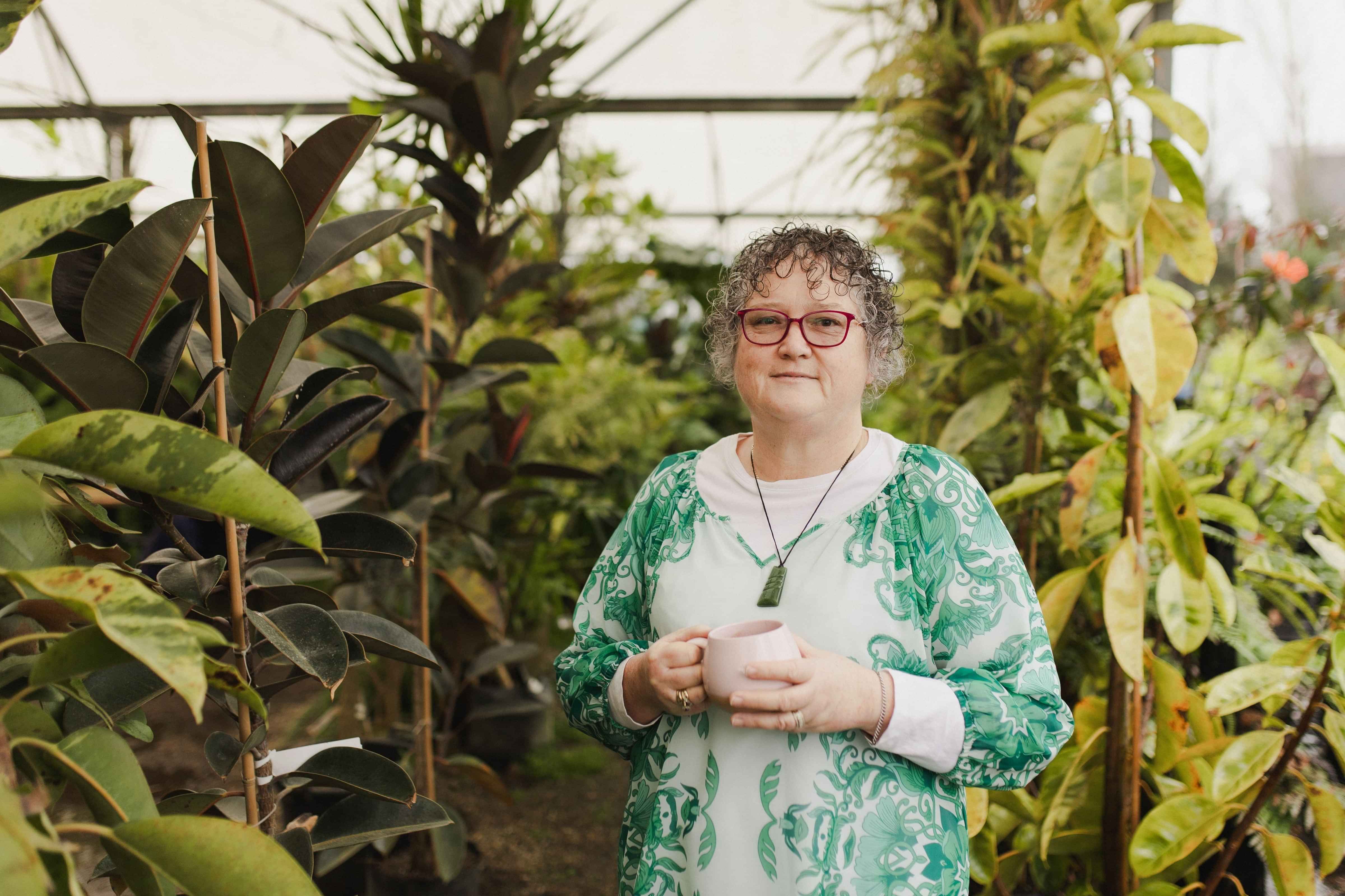 Image of life coach, Denise Mayhew-Leat writing in her notebook with a cup of hot chocolate. Waikato.