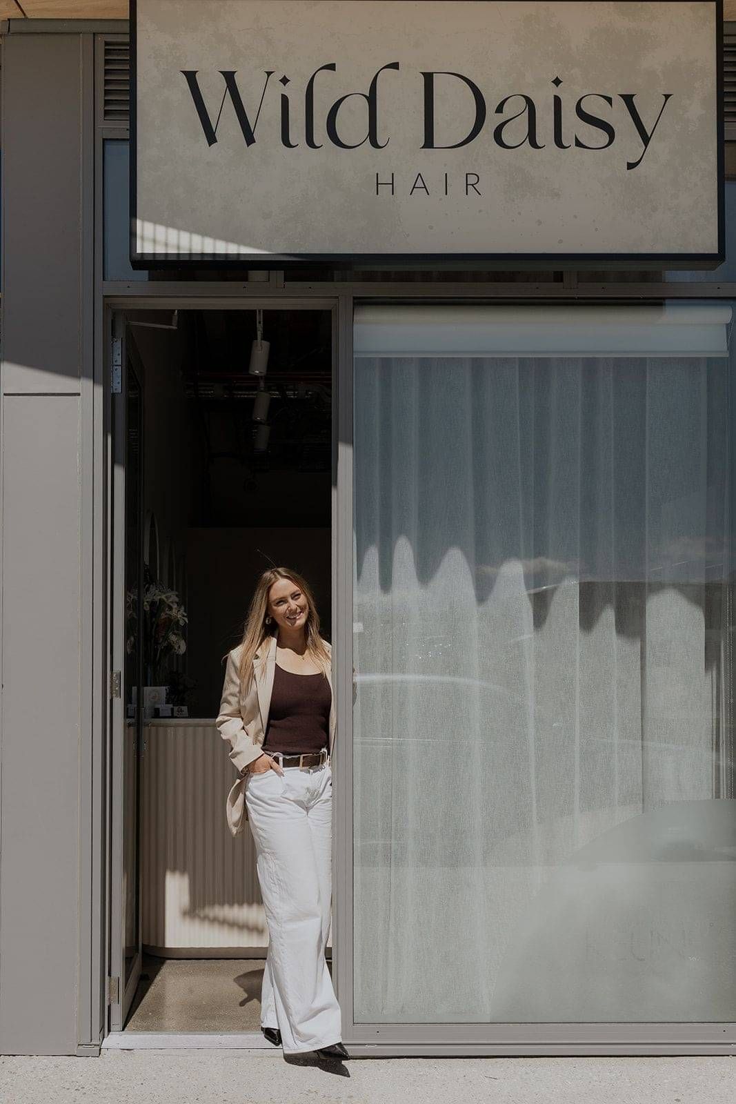 Wild Daisy Hair owner Haley Bower standing outside of her hair salon in Frankton, Queenstown.
