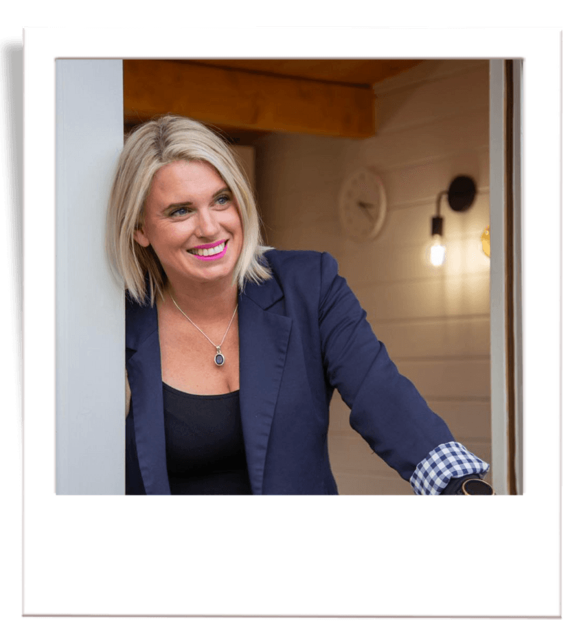 Amy of Auburn and Ash Hair at the door of her hair salon.