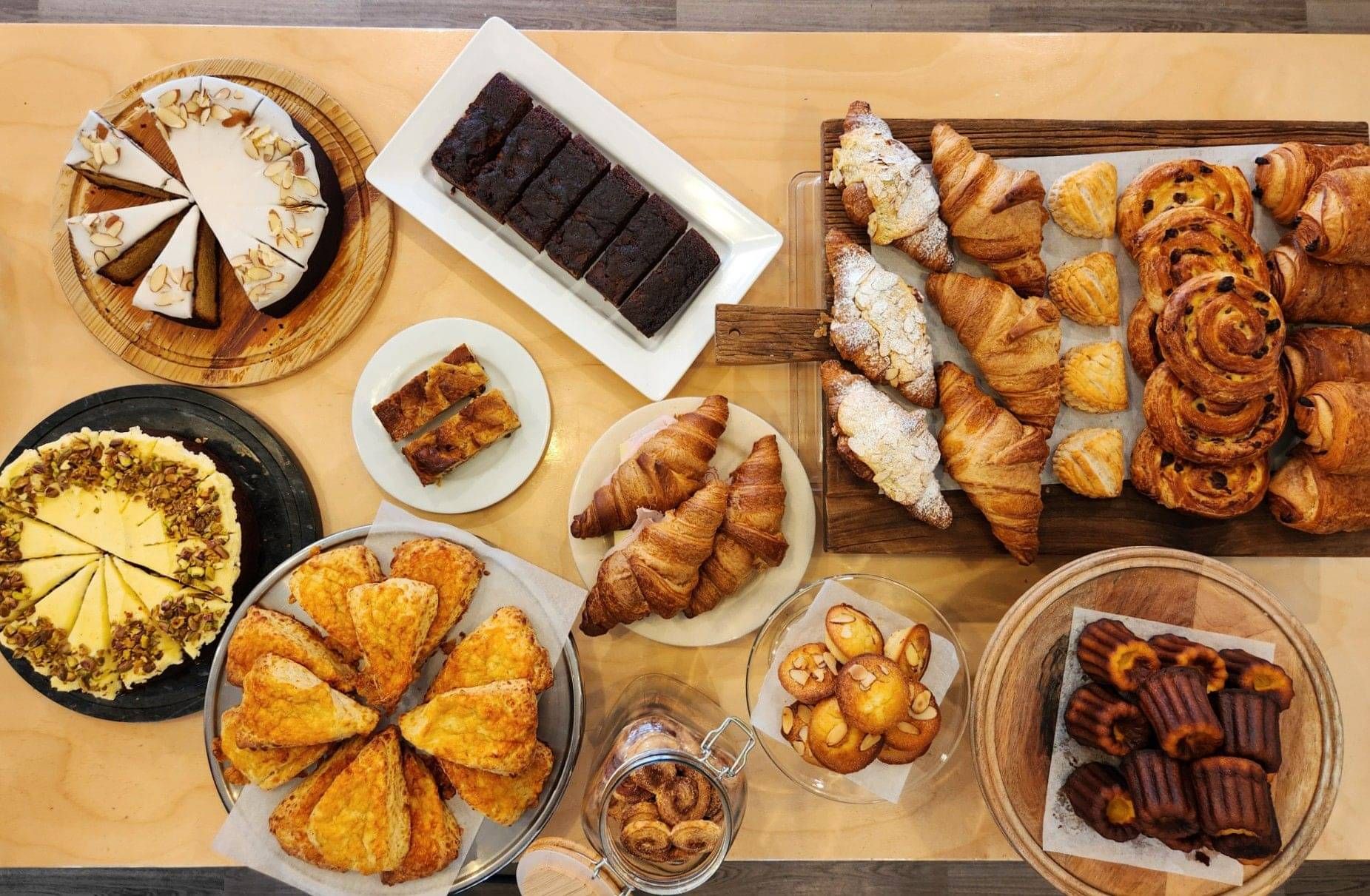 over top Photo of Pastries, cakes and sweet treats. at the bottom the world famous cheese scone is in full view.