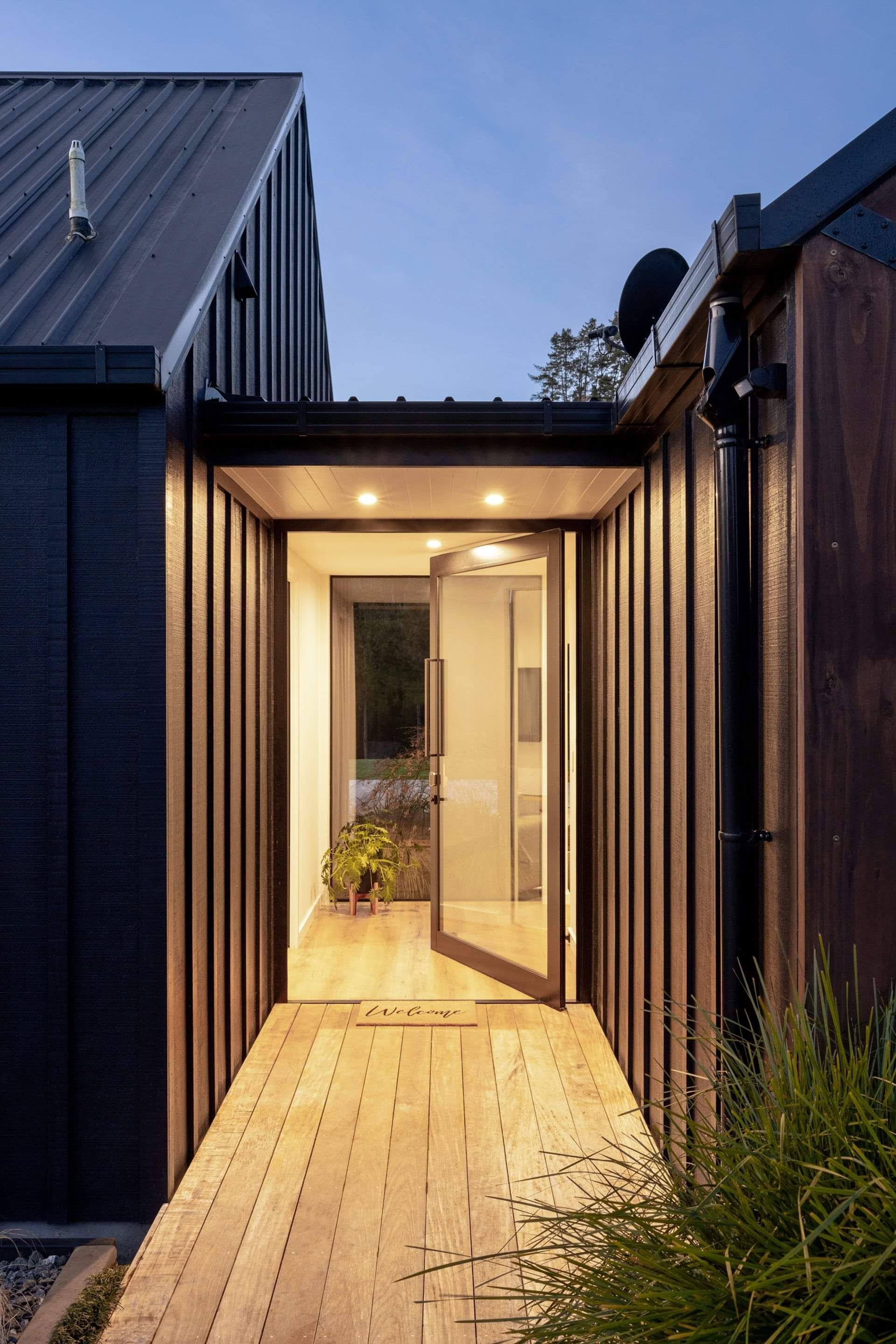 A close-up image of a new home build, with warm lighting illuminating the inside of the home.