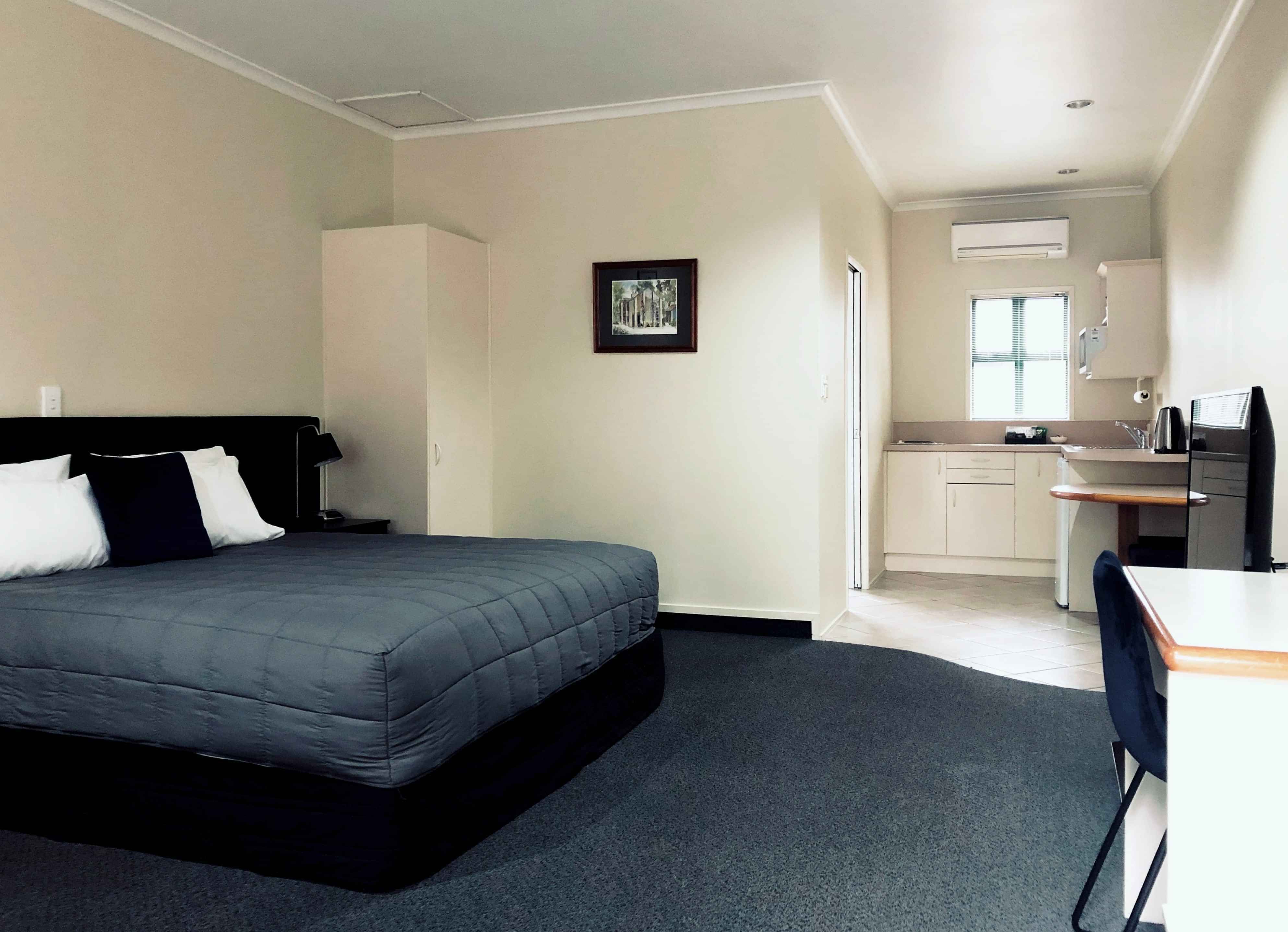 Super King Studio unit at Cambridge Mews showing bed and kitchen