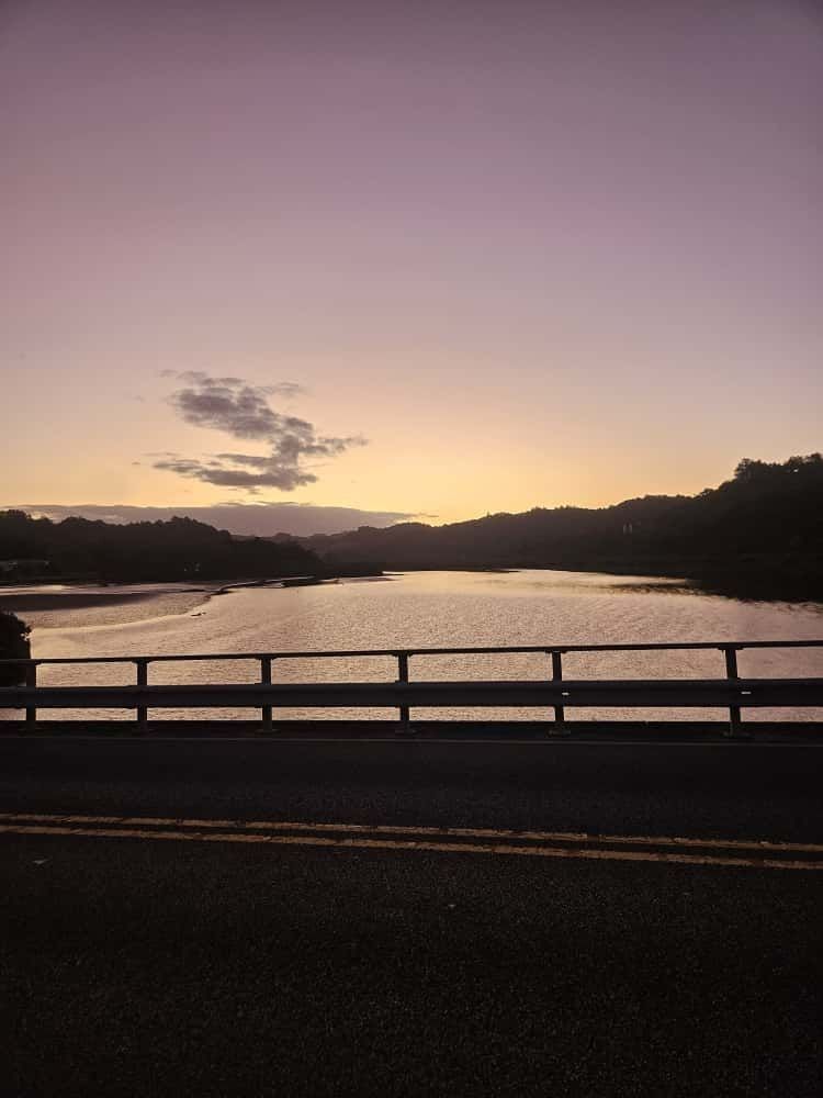 Image from on a bridge overlooking a river at sunset in new zealand