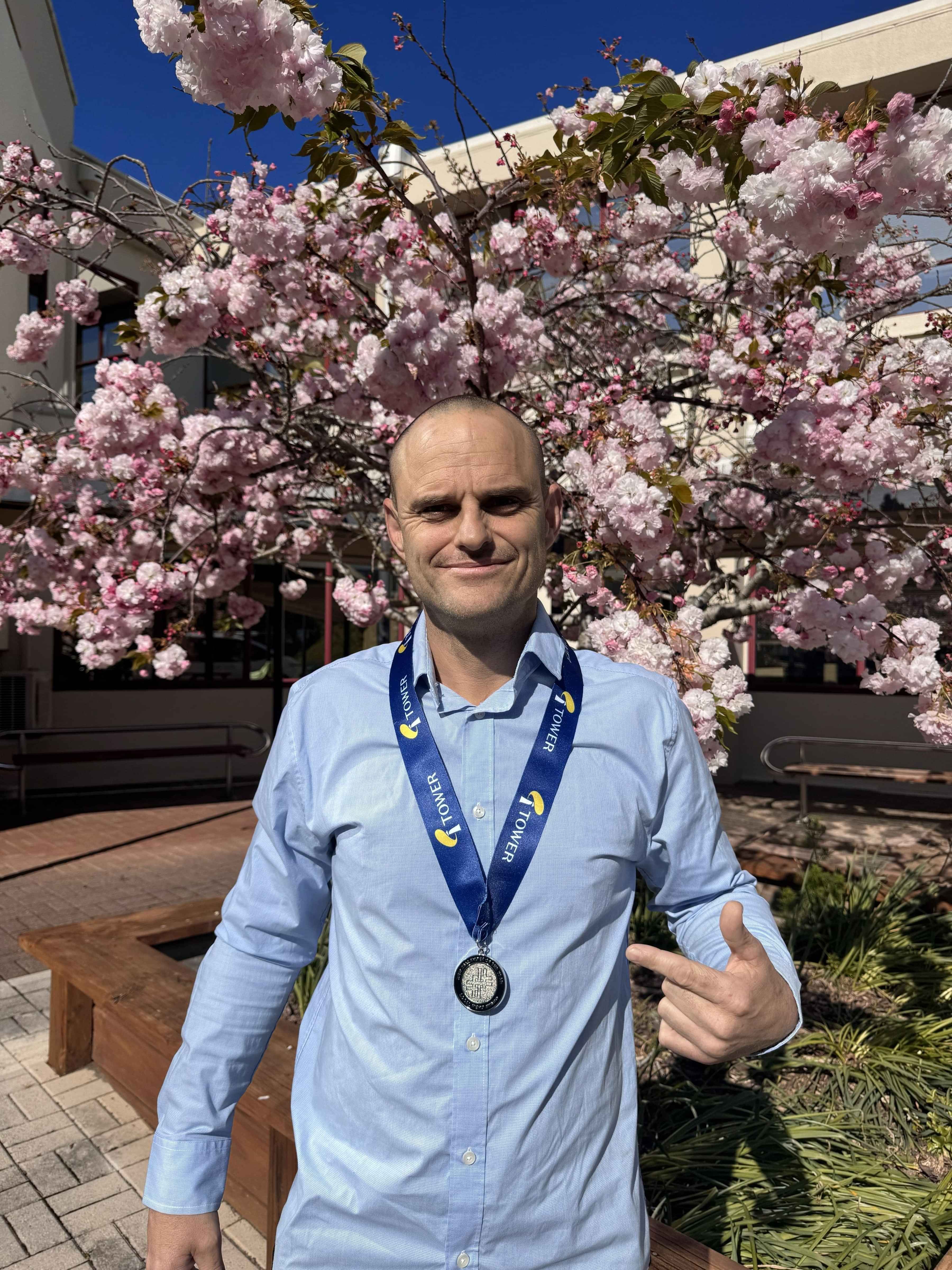 Cape Reinga lighthouse from afar with the ocean in the background