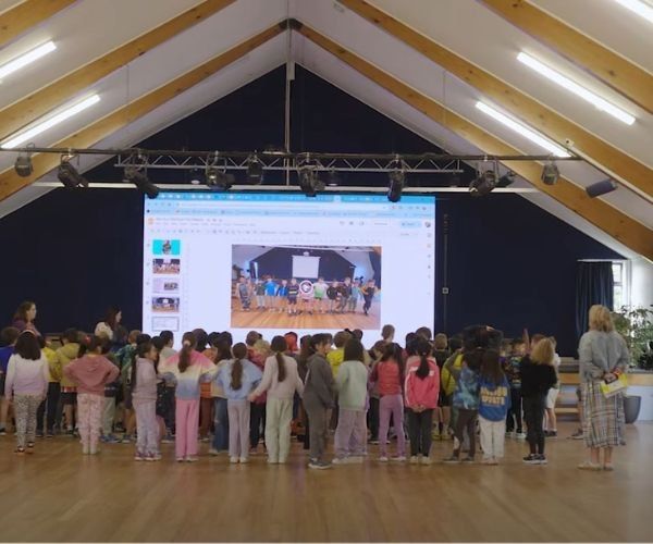 Children standing front of large LED screen