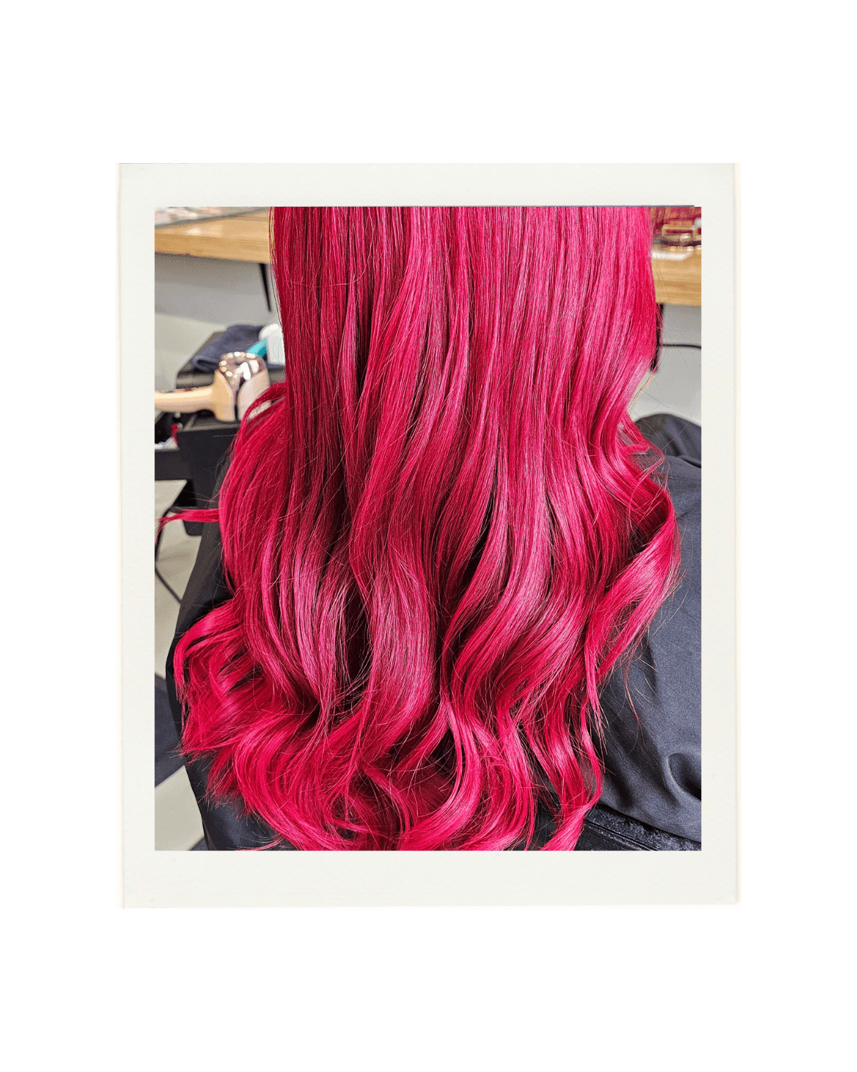 A polaroid style image of a bright red/pink hair colour created by Hair by Shiyee.