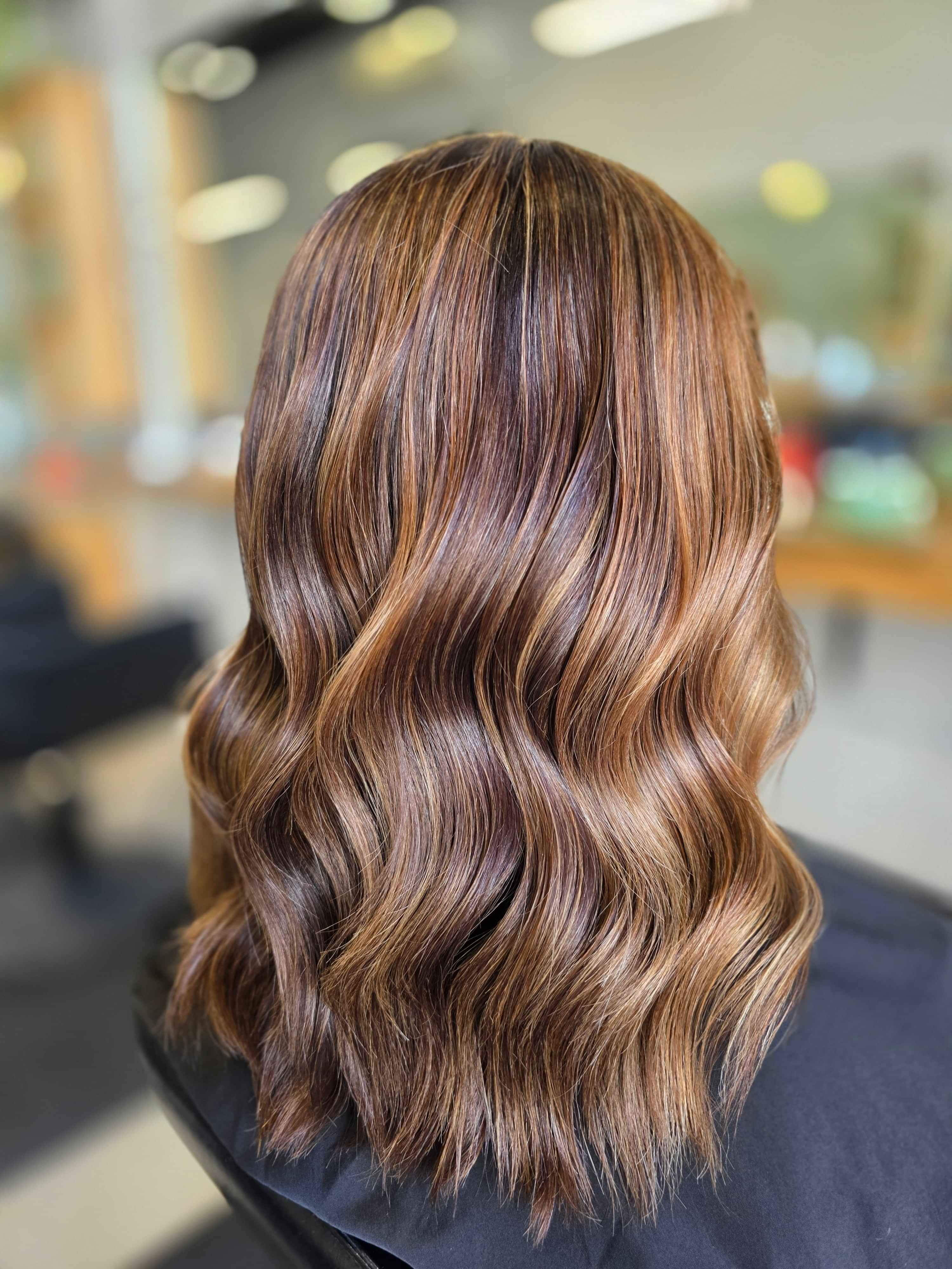 A polaroid style image of a wavy blonde bob created by Hair by Shiyee.