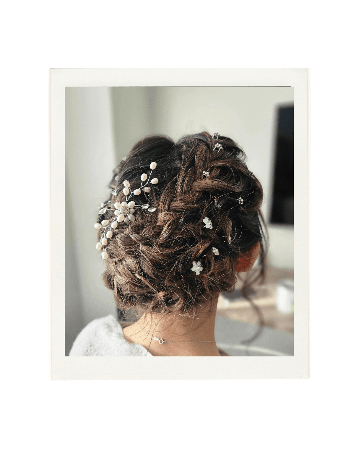 A polaroid style image of an elegant hair up created by Hair by Shiyee.