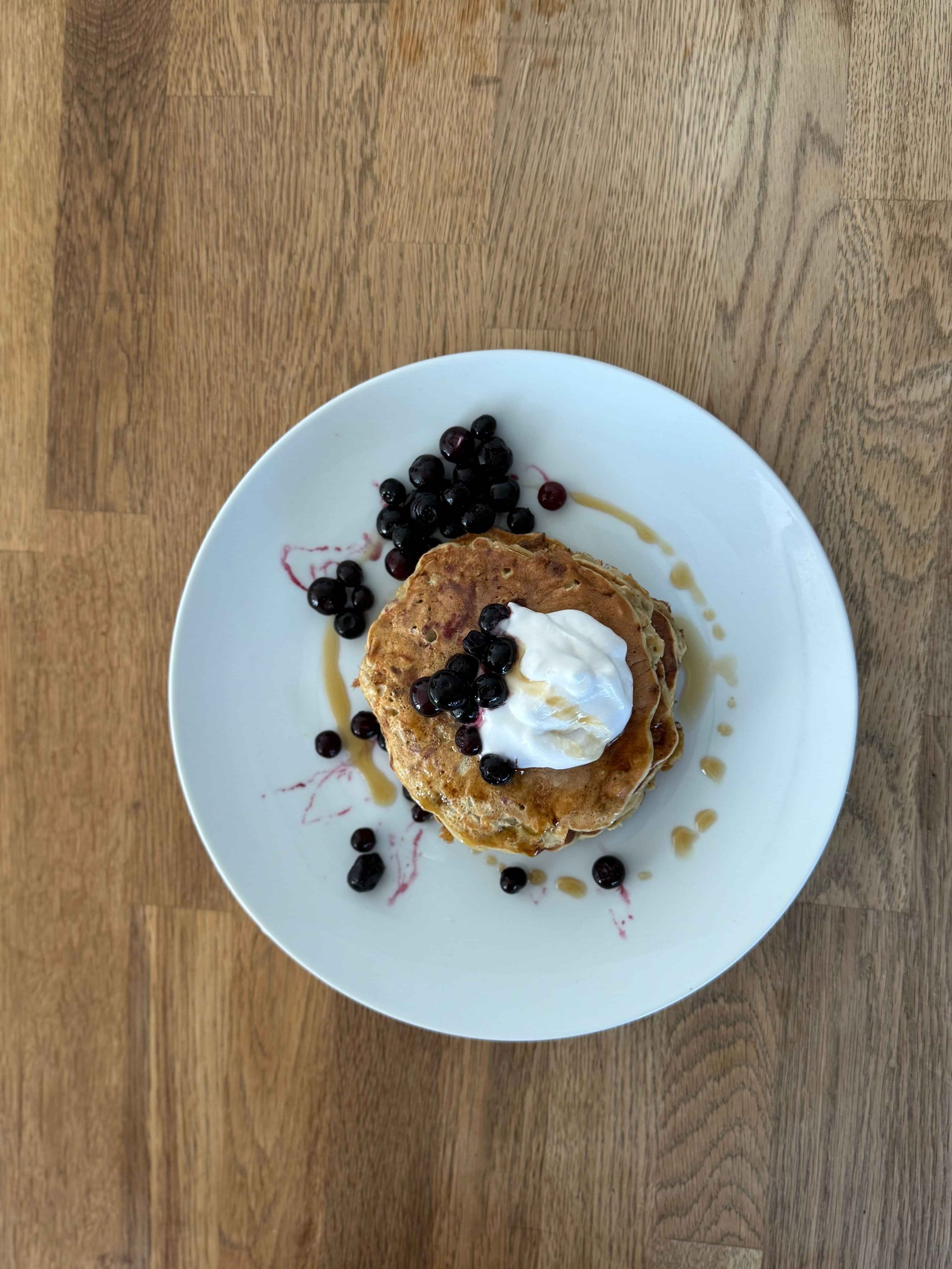 photo of oarty pancakes with blueberries and yoghurt on top