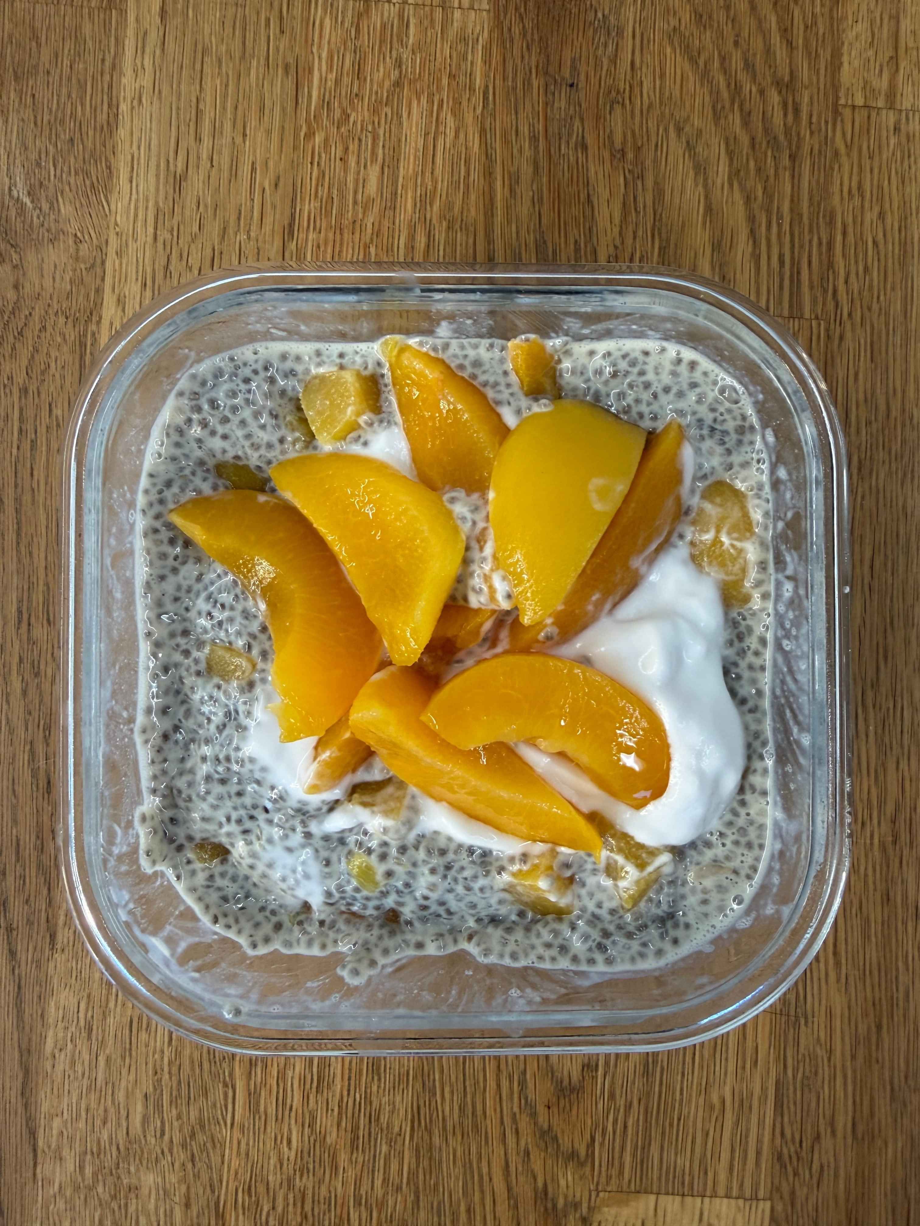 photo of chia seed pudding with peaches and yoghurt on top