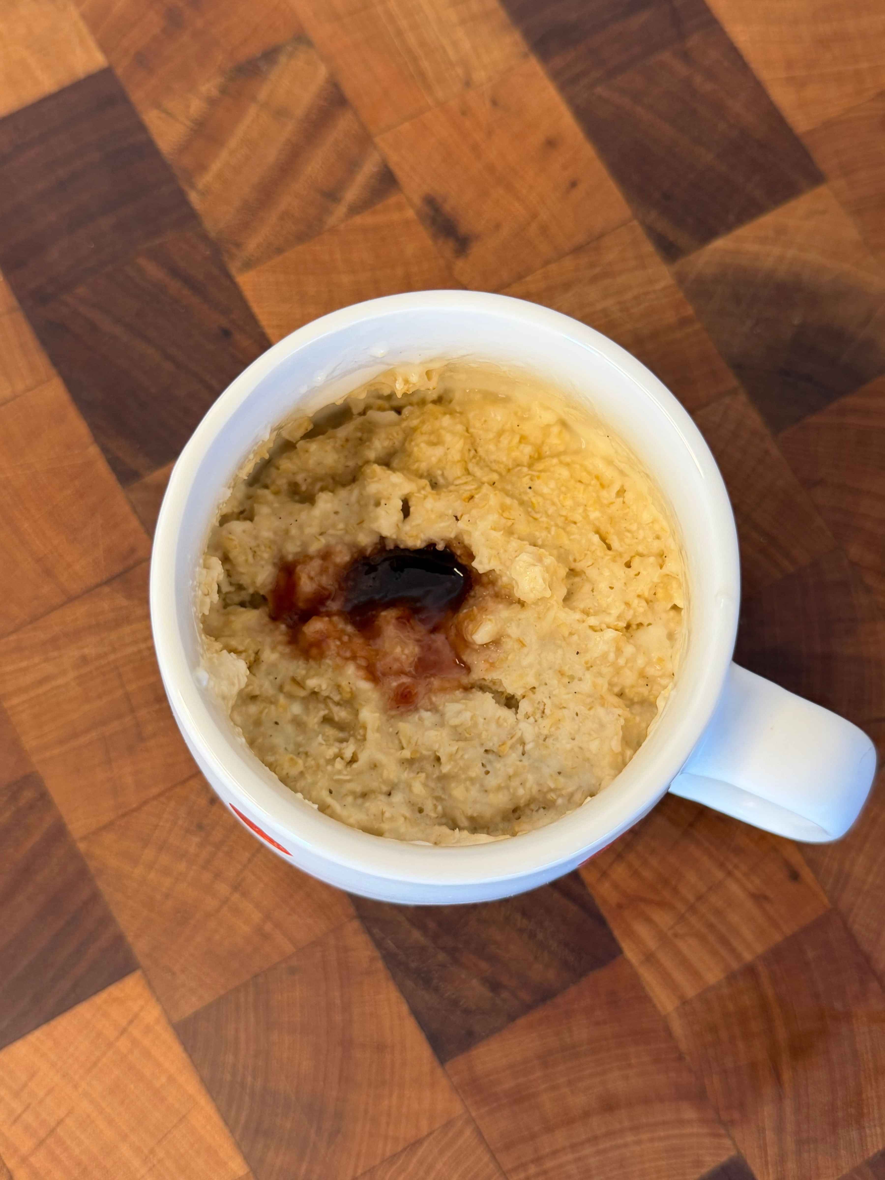photo of a cake with jam made in a mug and microwaved