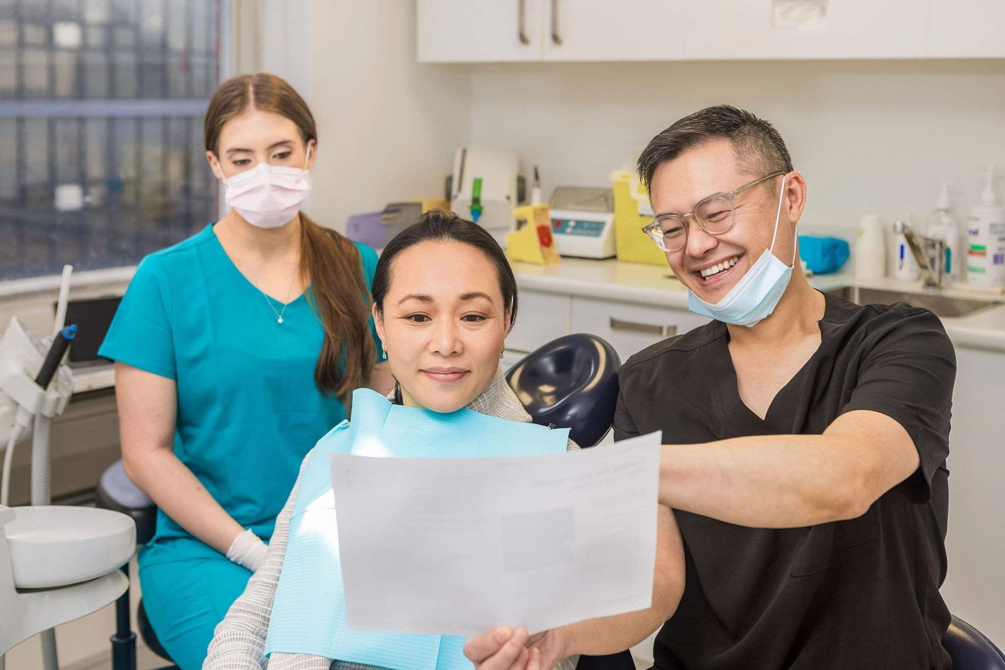 Dentist showcasing teeth whitening care guide to patient