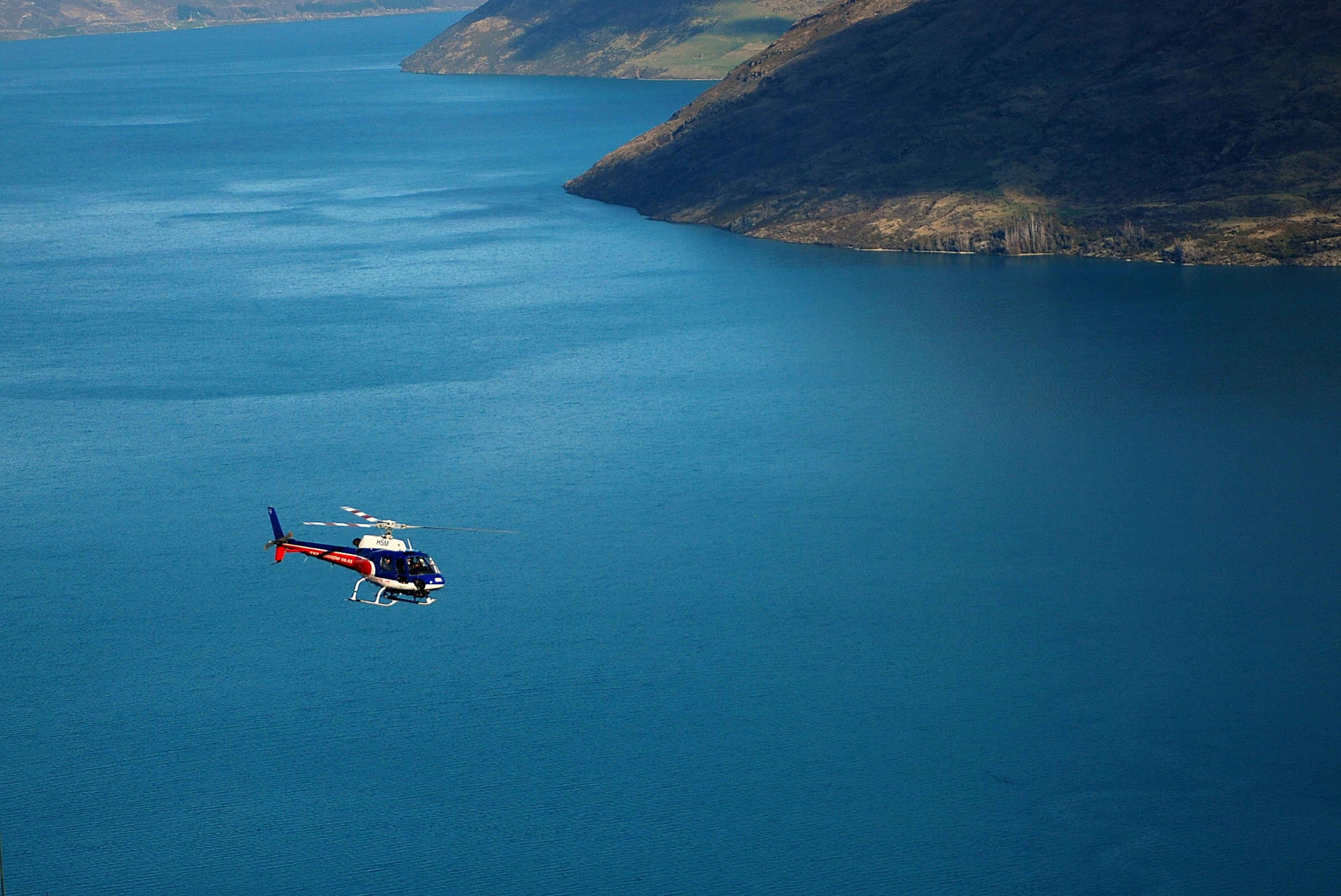 Helicopter flying over alpine lakes in the Mackenzie Basin