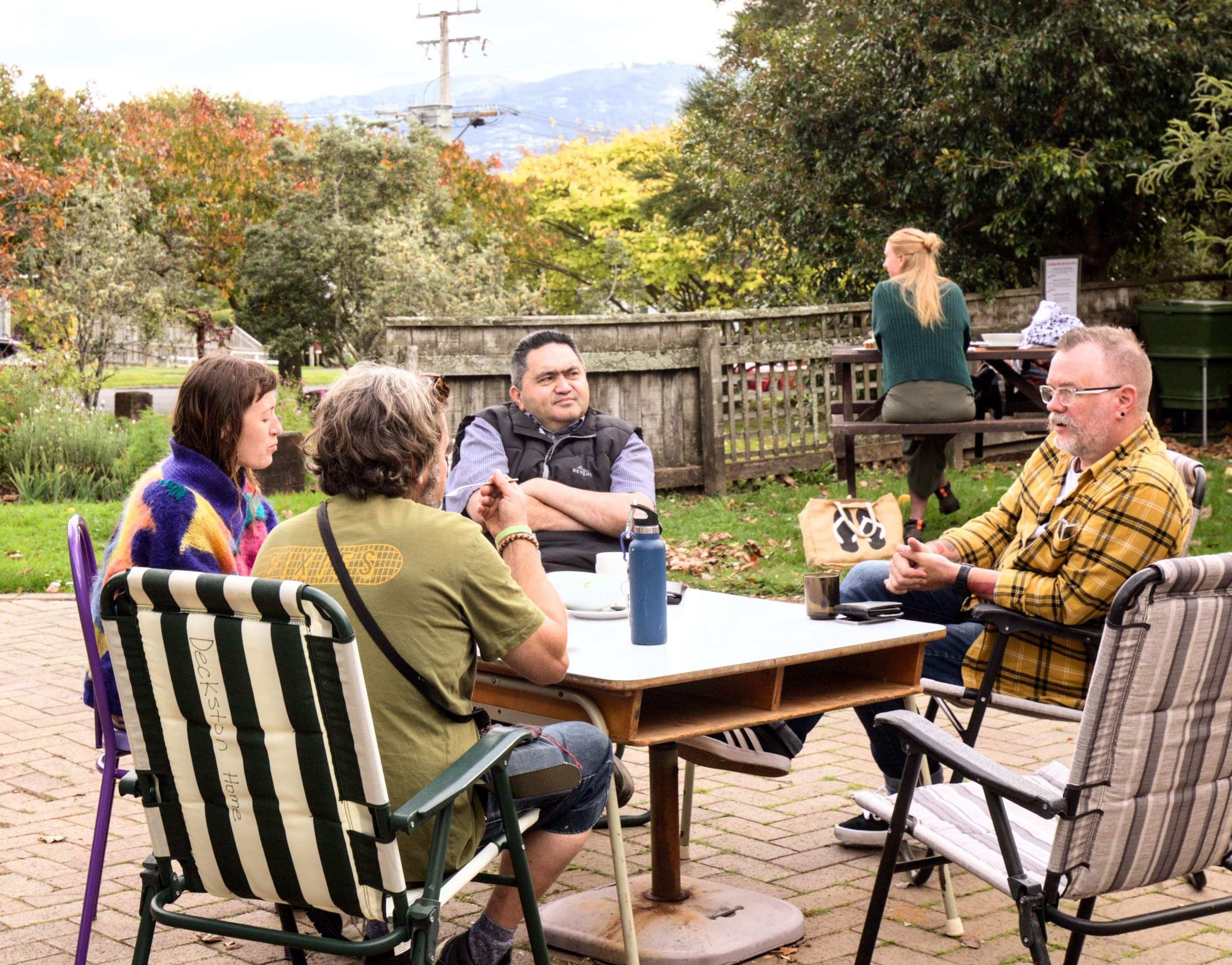 People relaxing around outdoor tables