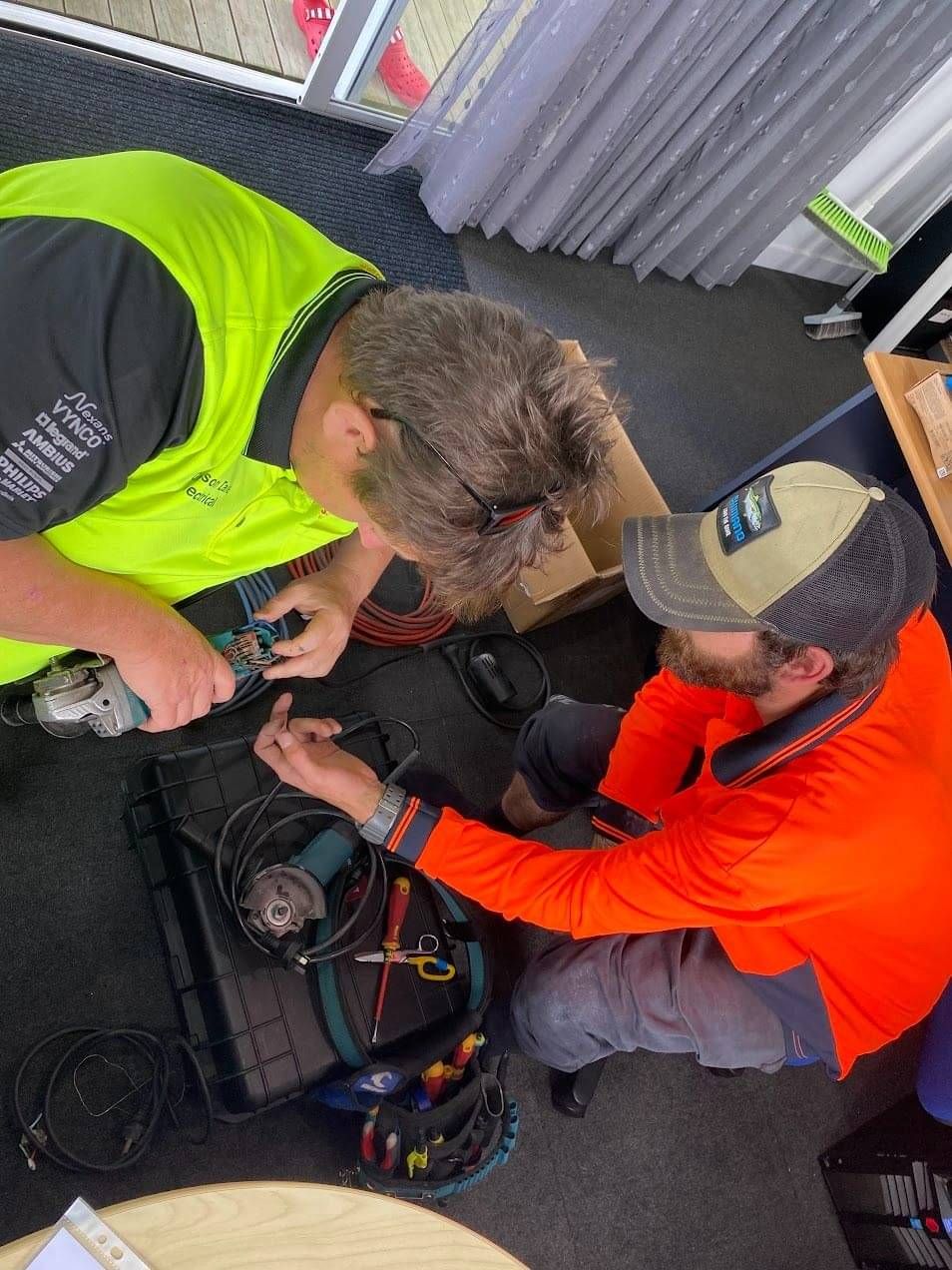 Grayson Dales and Dre fixing an electronic device